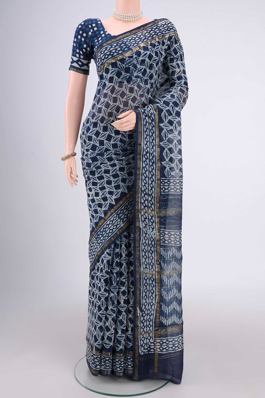 Indigo Maheshwari Silk Cotton Saree with Batik Print on the body and Zari Border.  displayed on a mannequin