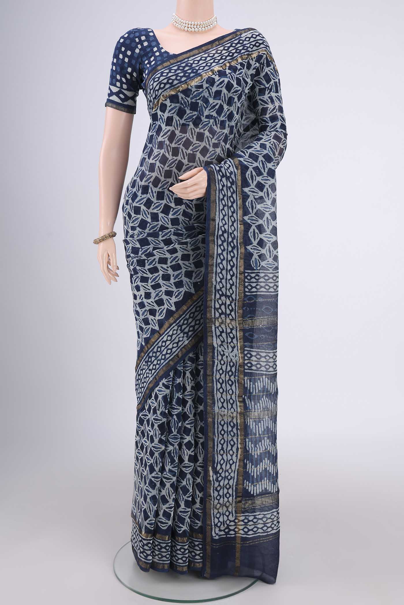 Indigo Maheshwari Silk Cotton Saree with Batik Print on the body and Zari Border.  displayed on a mannequin