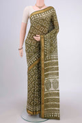Mehandi Green Maheshwari Silk Cotton Saree with Batik Print on the body and Zari Border.  displayed on a mannequin