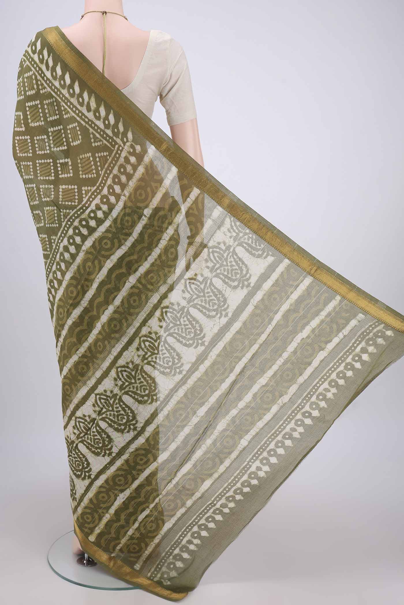 Flat view of Mehandi Green Maheshwari Silk Cotton Saree with Batik Print on the body and Zari Border. 