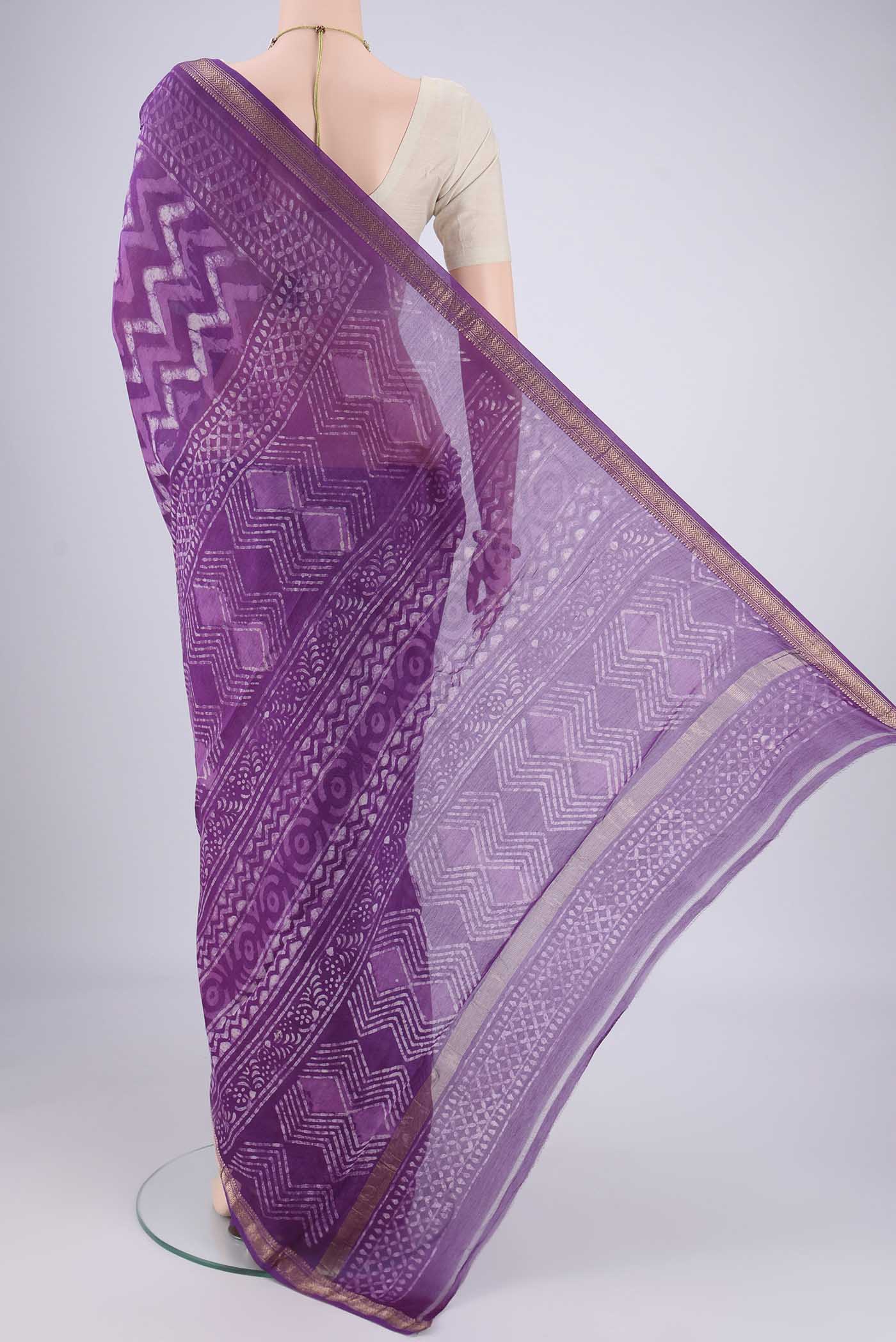 Flat view of Magenta Maheshwari Silk Cotton Saree with Batik Print on the body and Zari Border. 