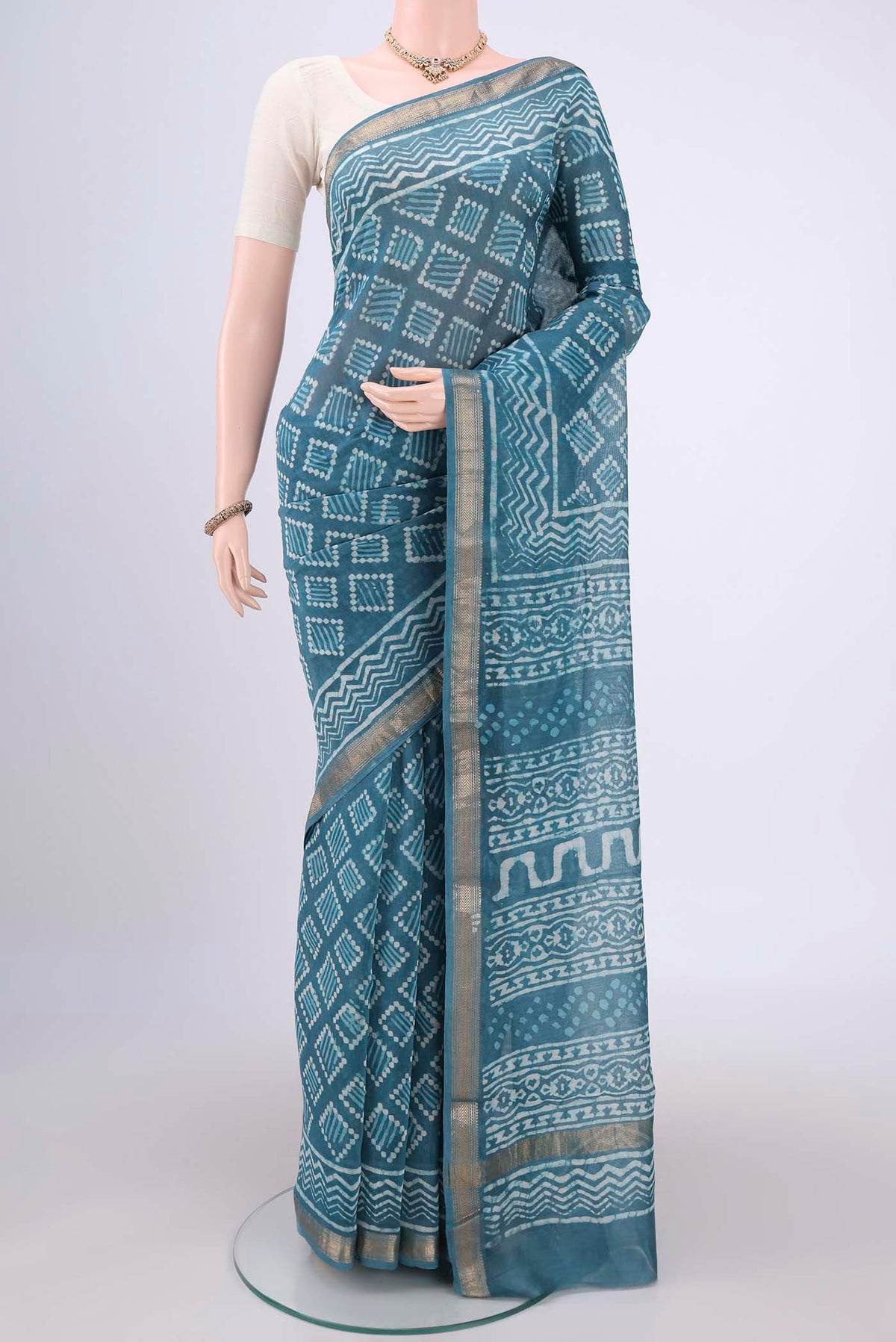 Maya Blue Maheshwari Silk Cotton Saree with Printed design on the body and Zari Border.  displayed on a mannequin