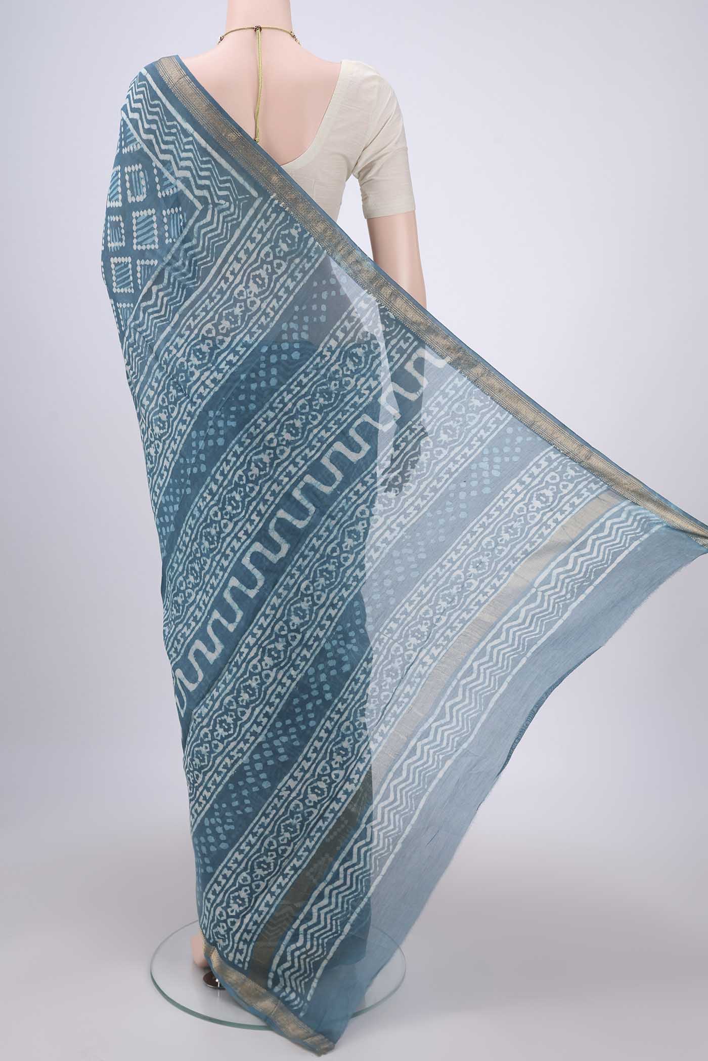Flat view of Maya Blue Maheshwari Silk Cotton Saree with Printed design on the body and Zari Border. 
