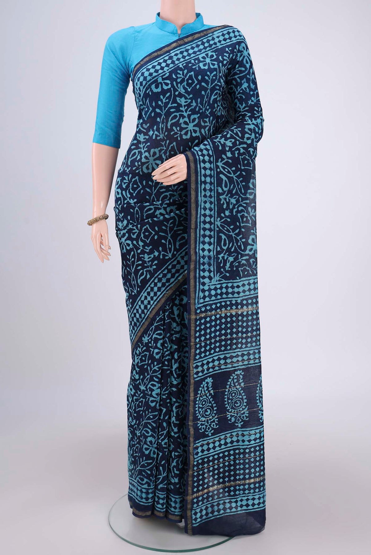 Navy Blue Chanderi Silk Saree with Batik Print on the body and Zari Border.  displayed on a mannequin