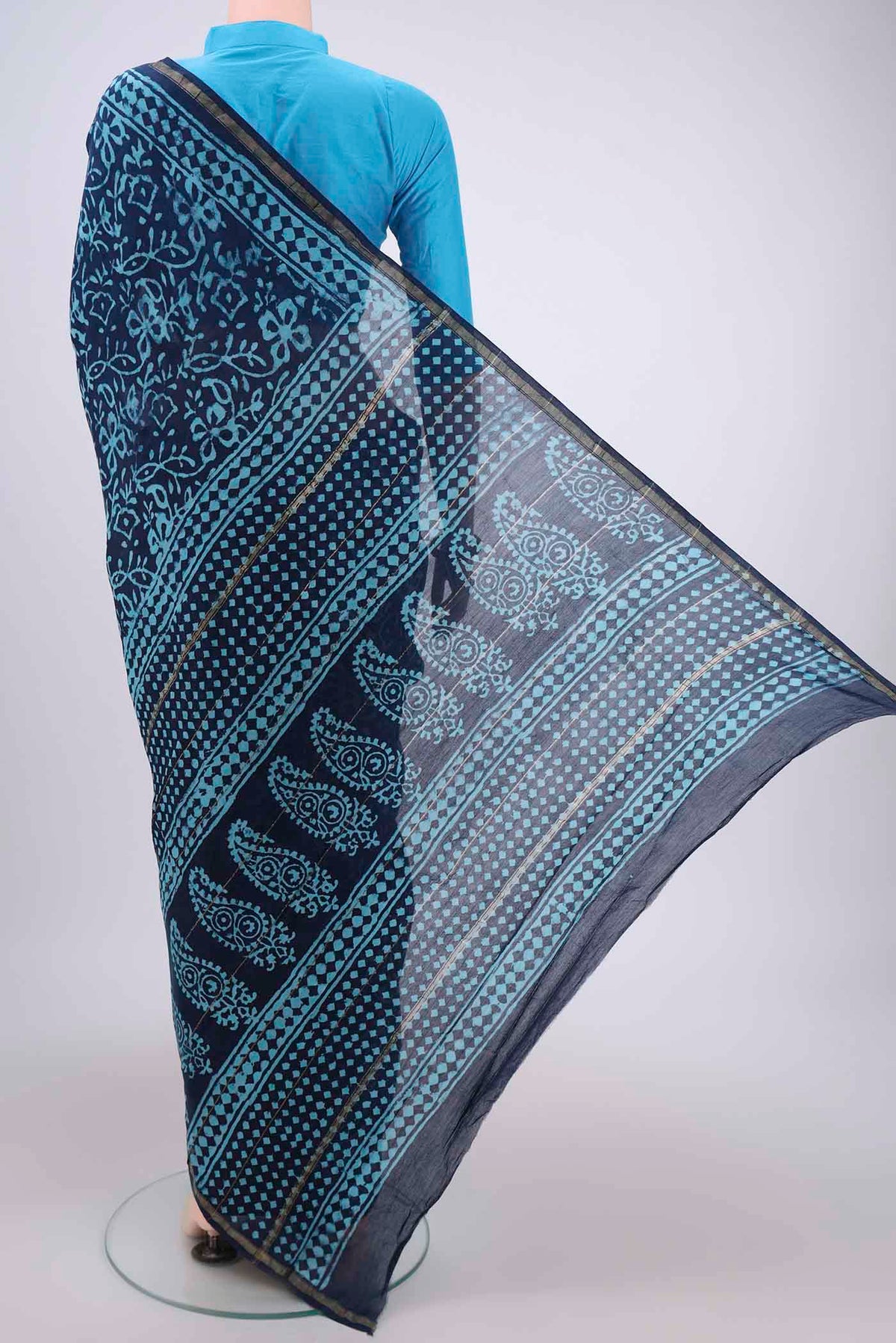 Flat view of Navy Blue Chanderi Silk Saree with Batik Print on the body and Zari Border. 
