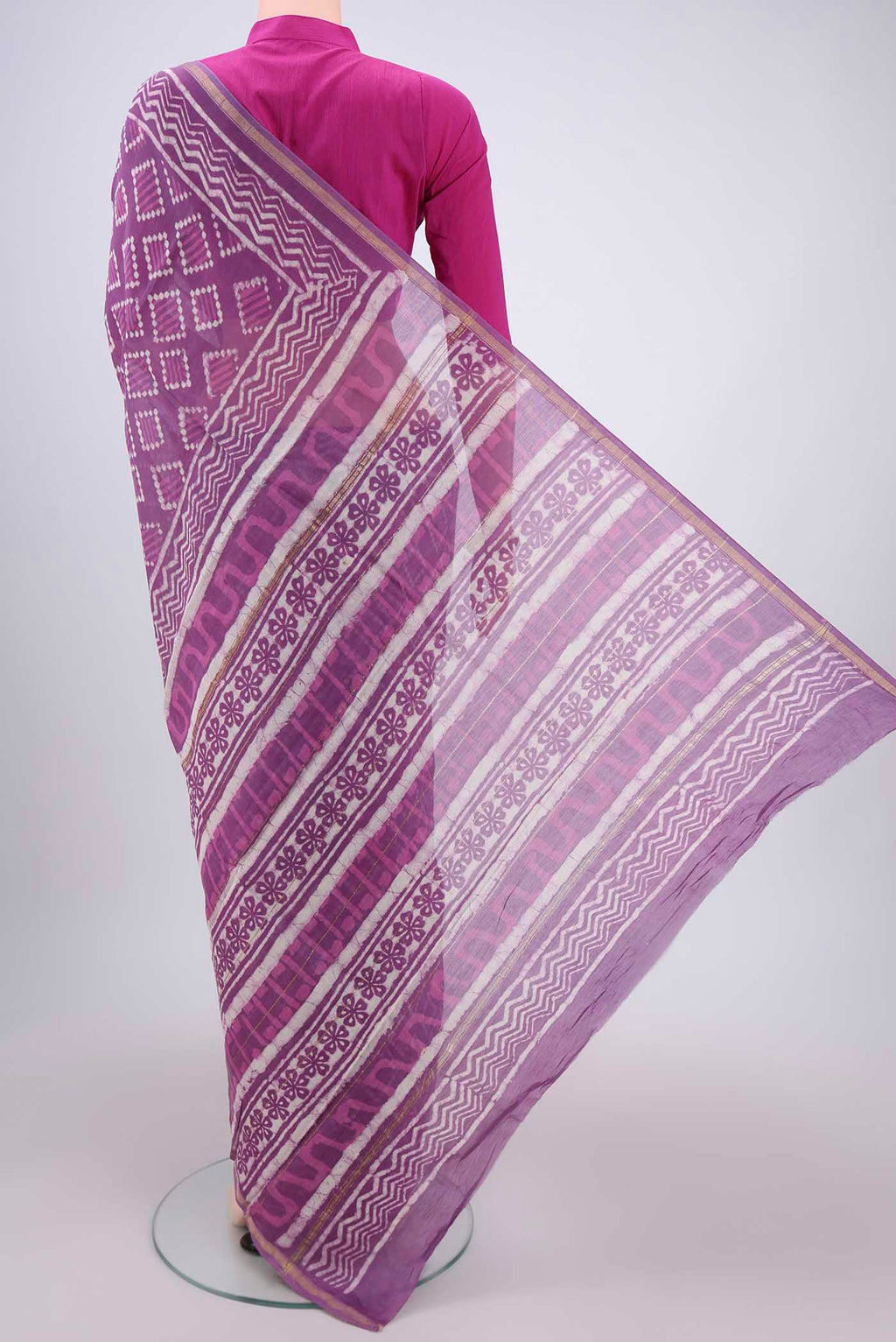 Flat view of Violet Chanderi Silk Saree with Batik Print on the body and Zari Border. 