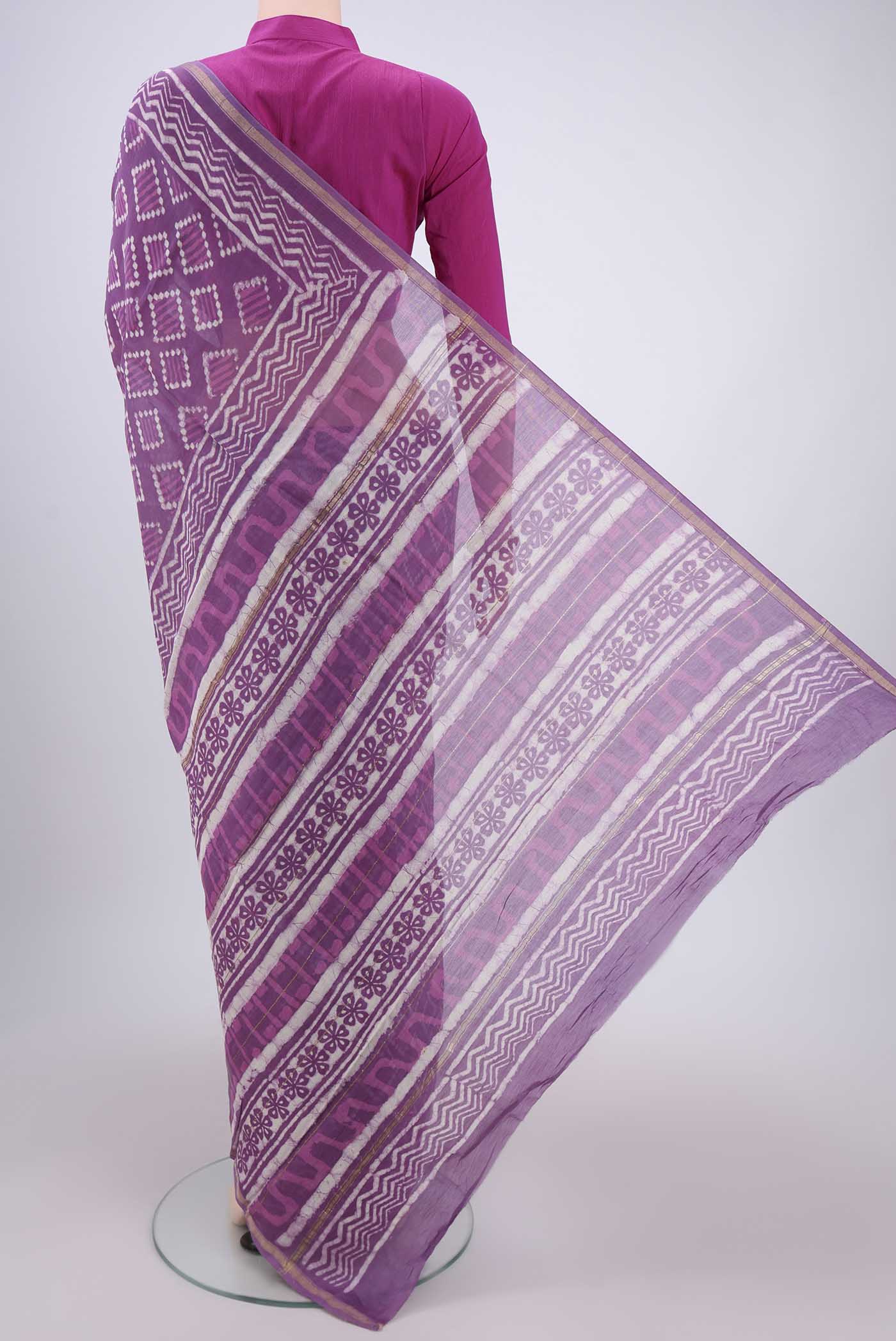 Flat view of Violet Chanderi Silk Saree with Batik Print on the body and Zari Border. 