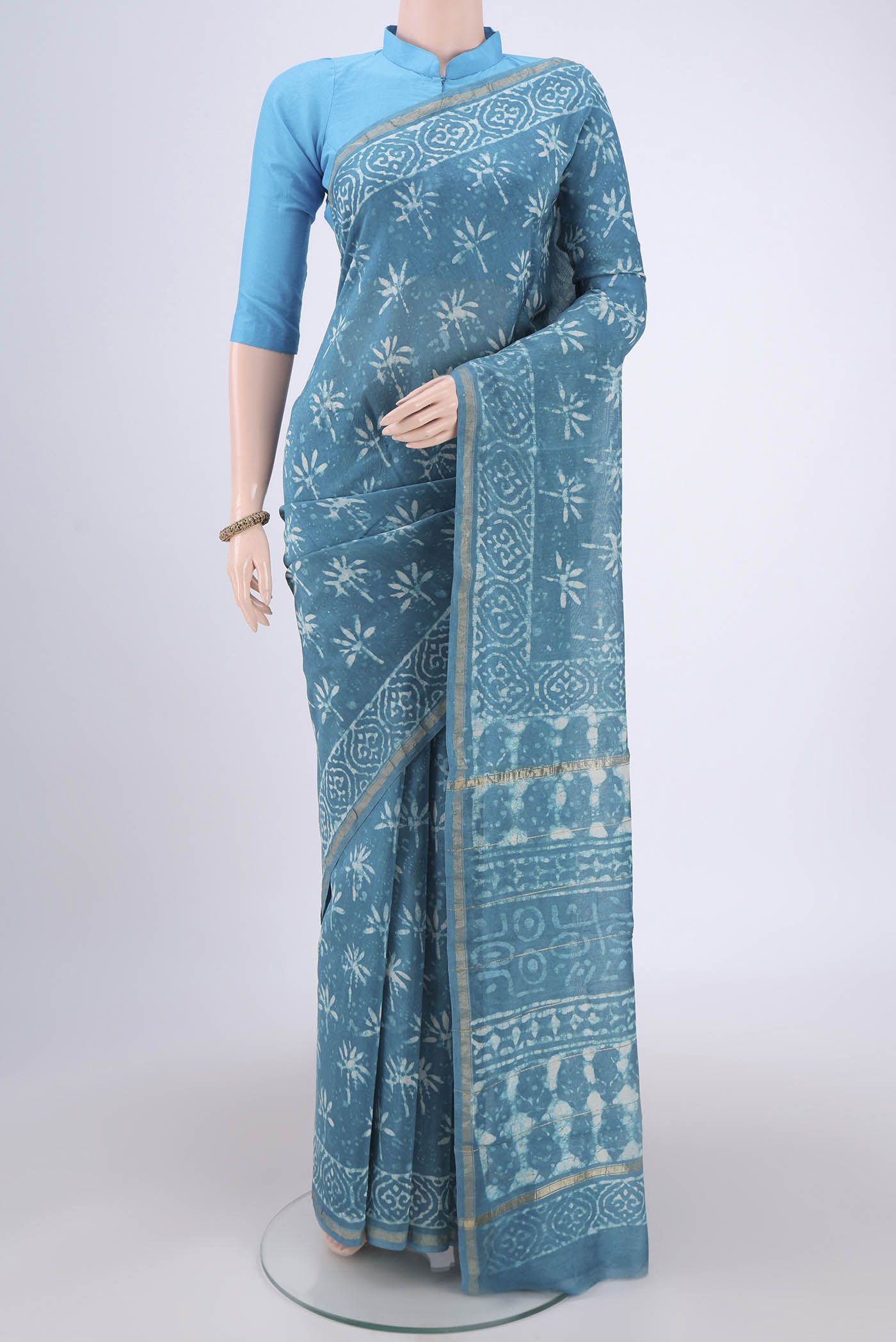Maya Blue Chanderi Silk Saree with Batik Print on the body and Zari Border.  displayed on a mannequin