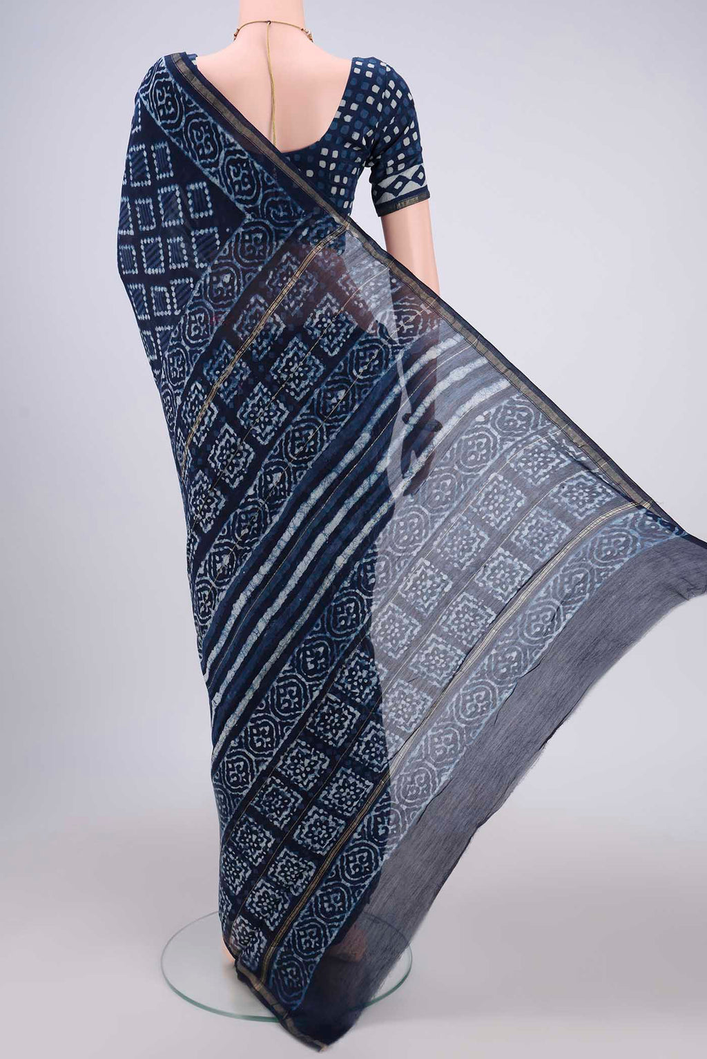 Flat view of Indigo Maheshwari Silk Cotton Saree with Batik Print on the body and Zari Border. 
