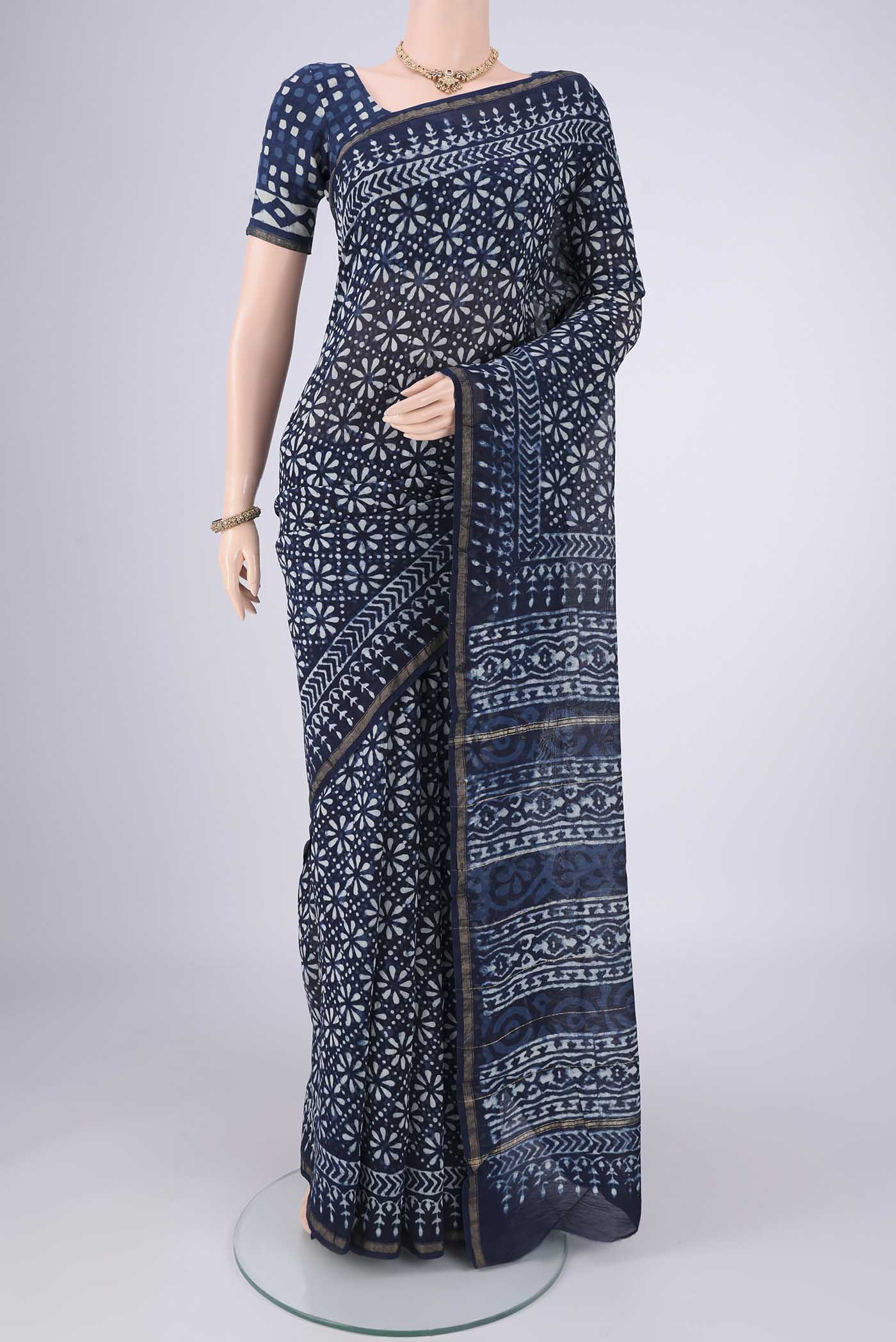 Indigo Maheshwari Silk Cotton Saree with Batik Print on the body and Zari Border.  displayed on a mannequin