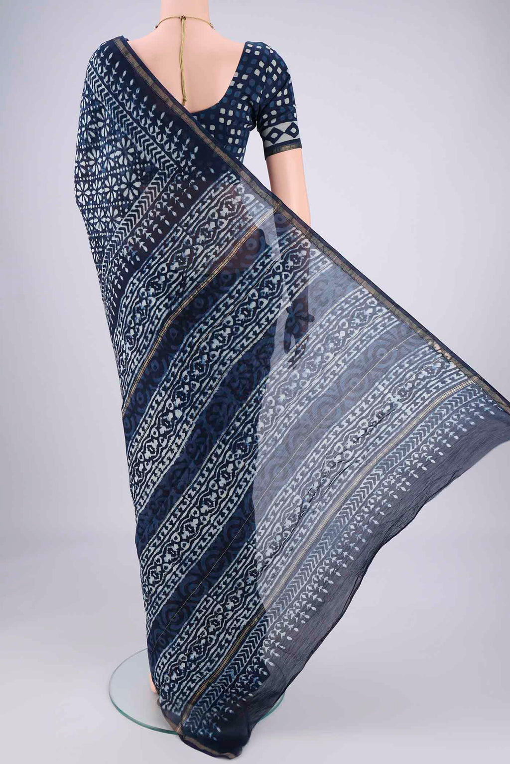 Flat view of Indigo Maheshwari Silk Cotton Saree with Batik Print on the body and Zari Border. 