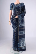 Indigo Maheshwari Silk Cotton Saree with Batik Print on the body and Zari Border.  displayed on a mannequin