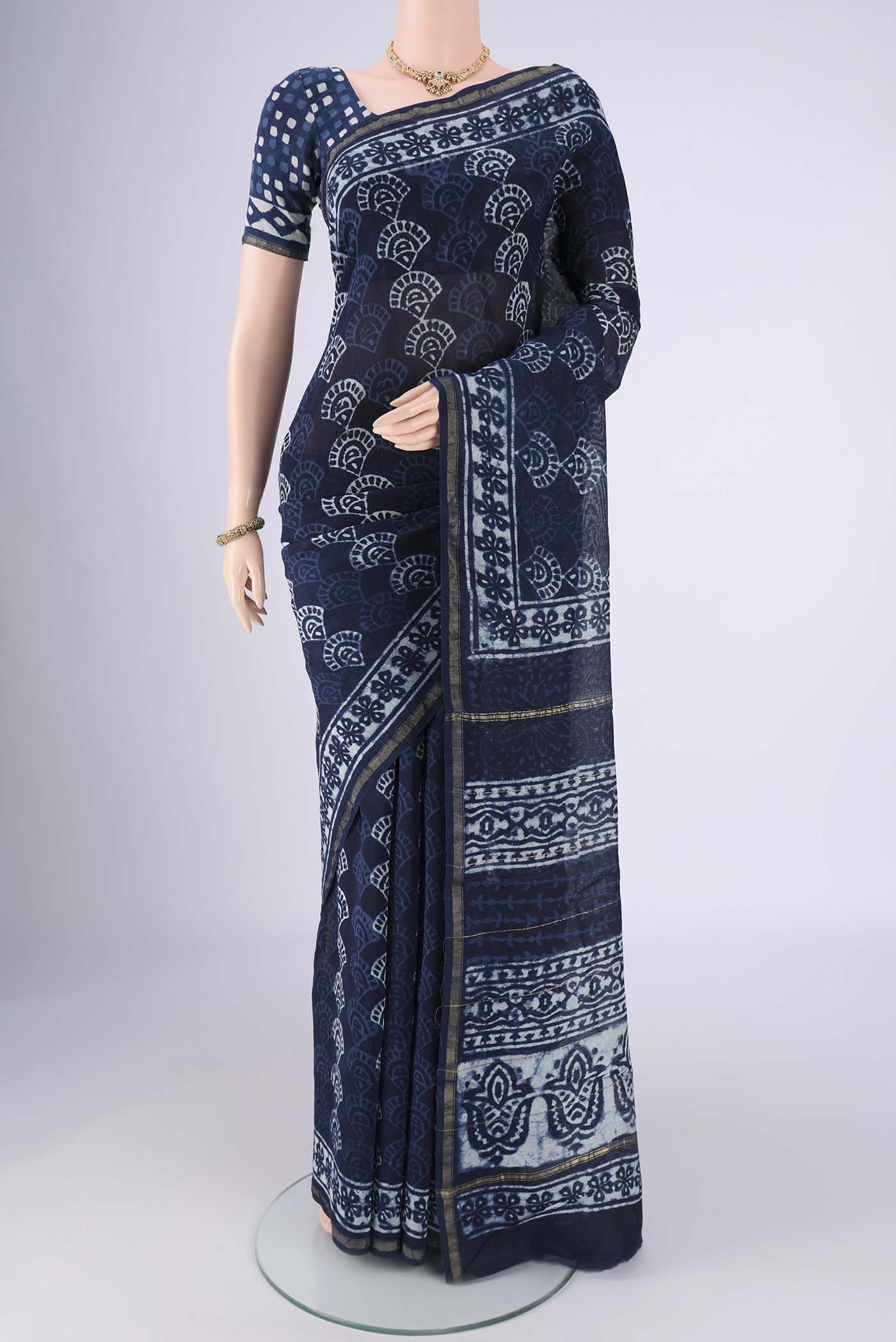Indigo Maheshwari Silk Cotton Saree with Batik Print on the body and Zari Border.  displayed on a mannequin