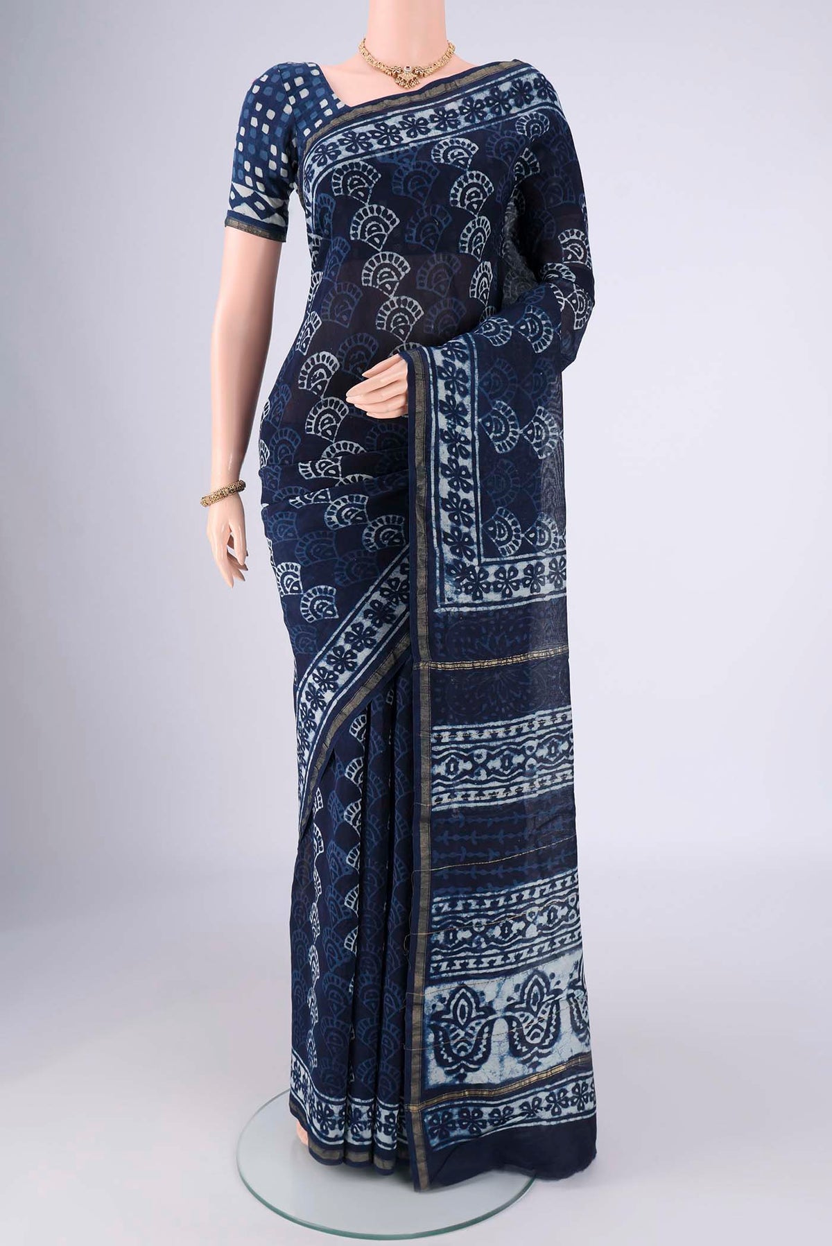 Indigo Maheshwari Silk Cotton Saree with Batik Print on the body and Zari Border.  displayed on a mannequin