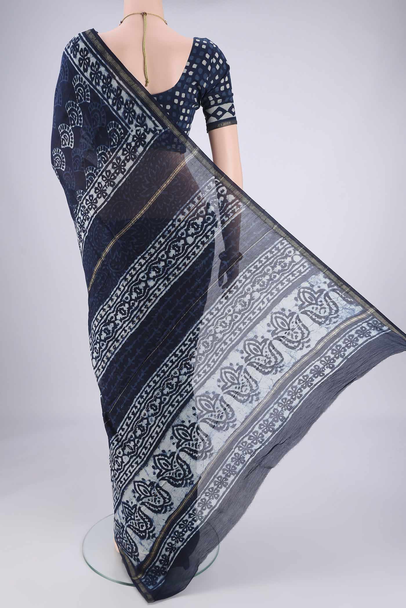 Flat view of Indigo Maheshwari Silk Cotton Saree with Batik Print on the body and Zari Border. 
