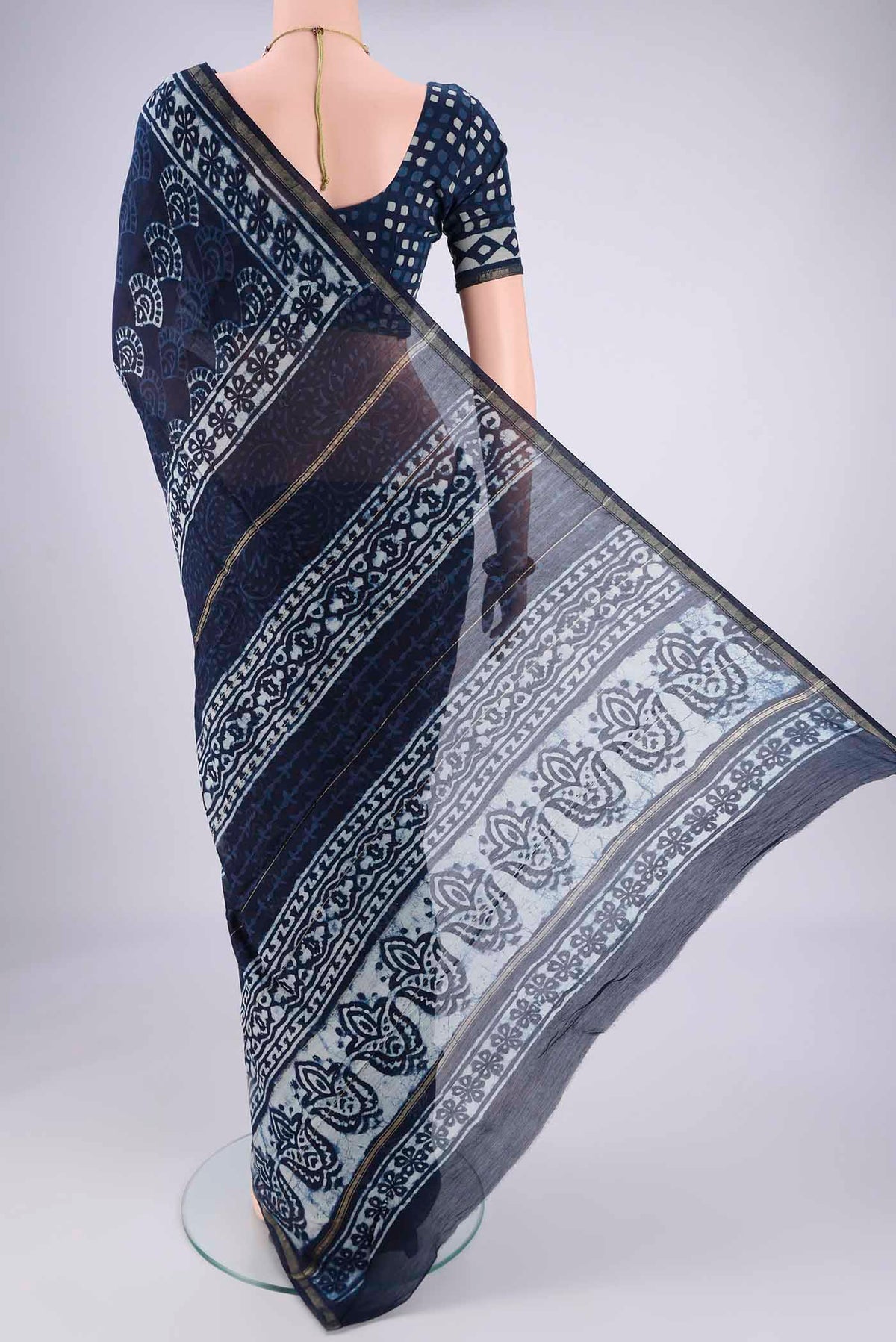 Flat view of Indigo Maheshwari Silk Cotton Saree with Batik Print on the body and Zari Border. 