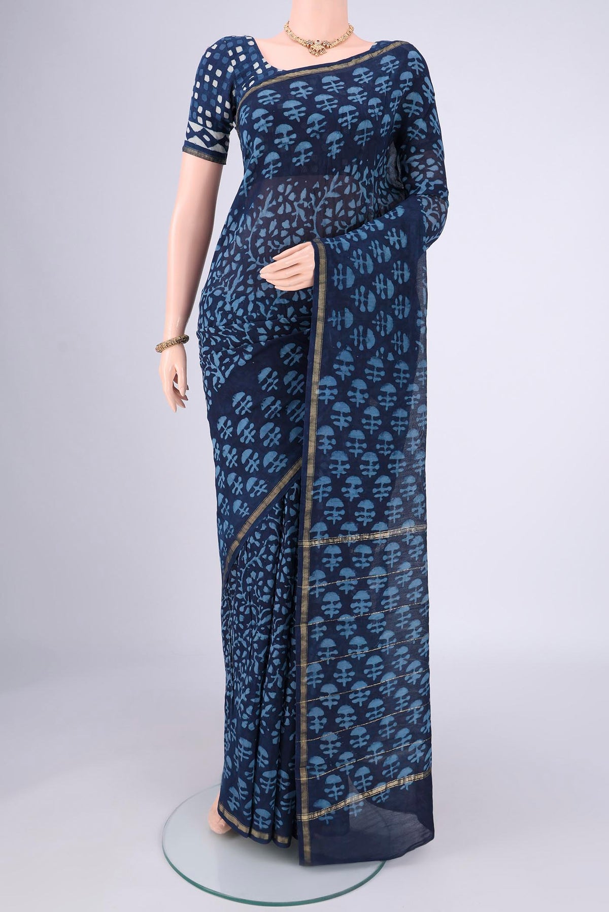 Indigo Maheshwari Silk Cotton Saree with Batik Print on the body and Zari Border.  displayed on a mannequin