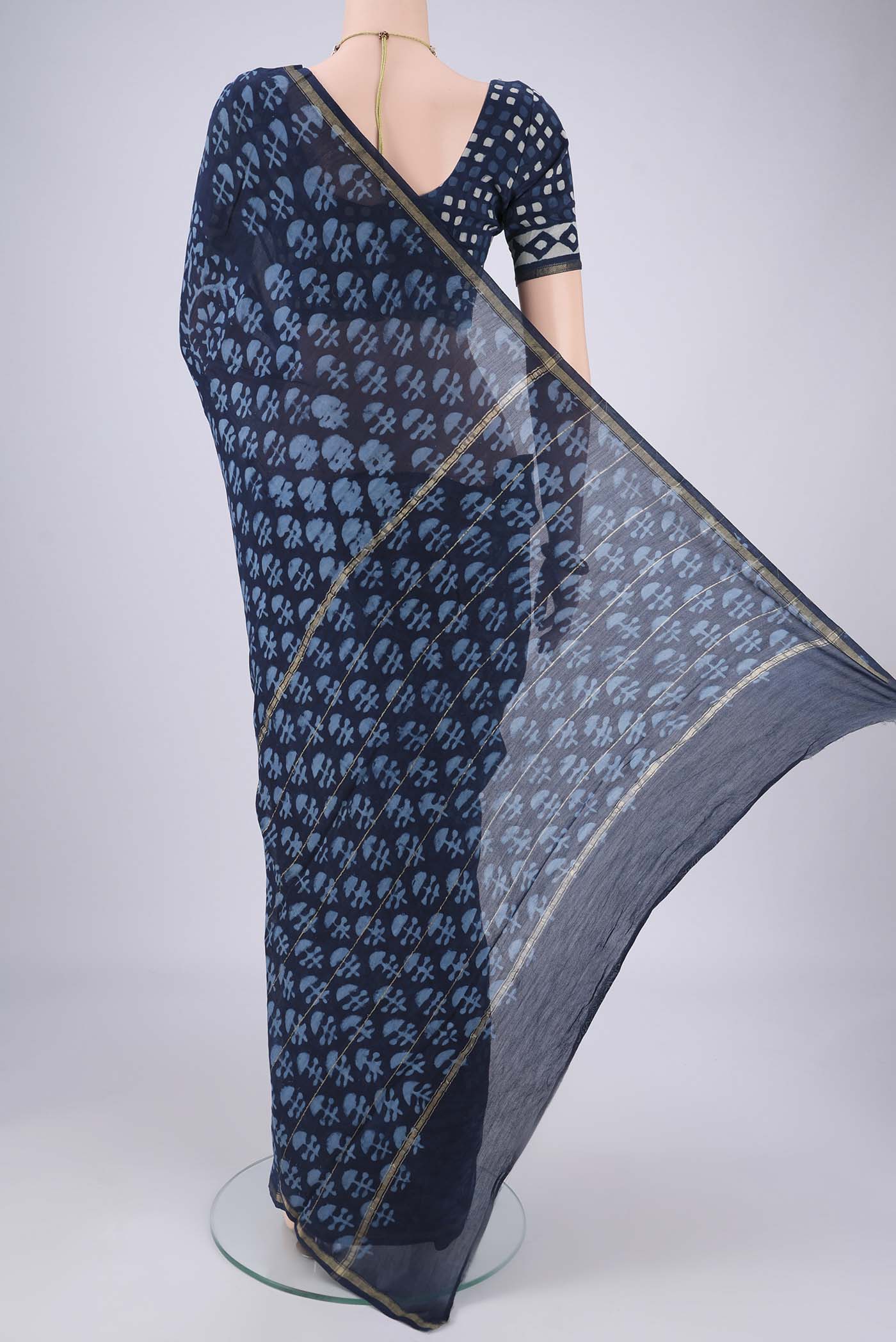 Flat view of Indigo Maheshwari Silk Cotton Saree with Batik Print on the body and Zari Border. 