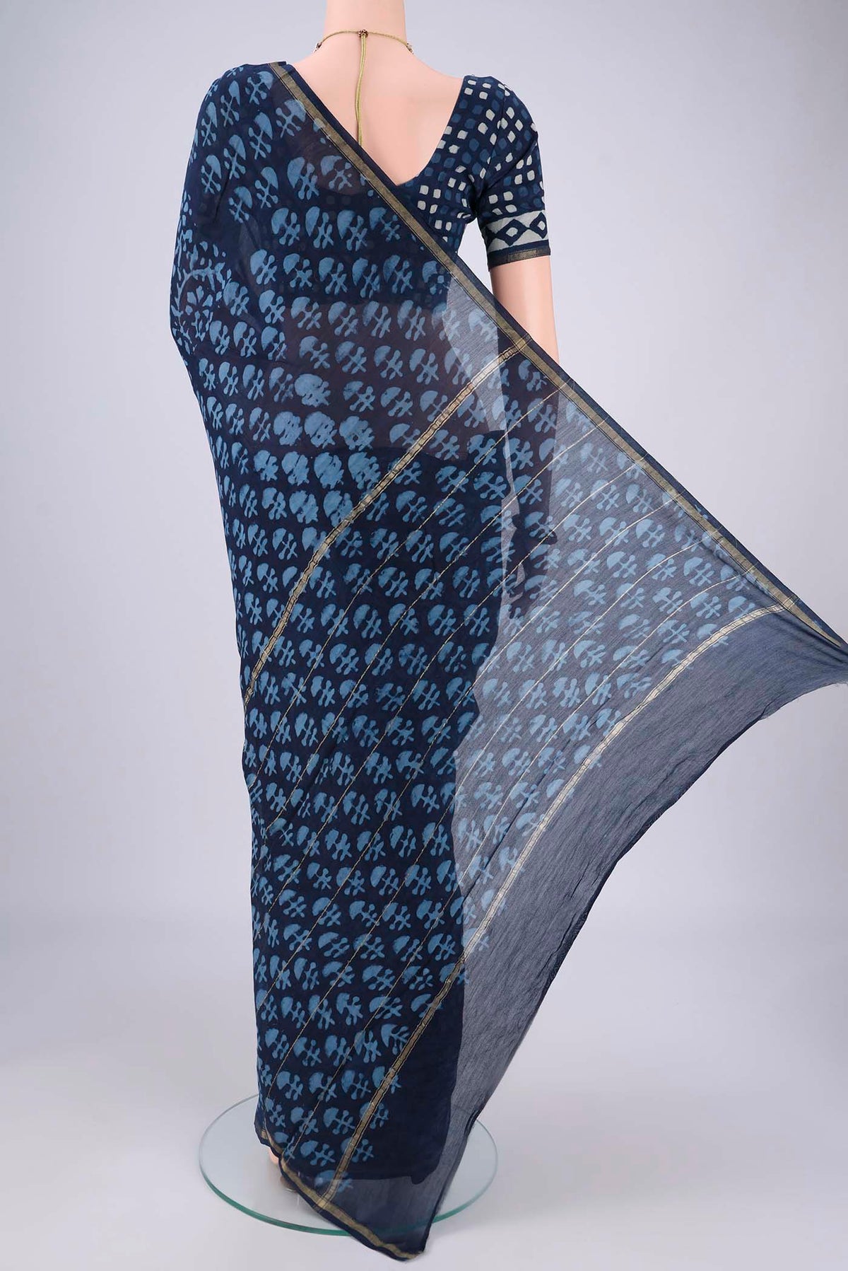 Flat view of Indigo Maheshwari Silk Cotton Saree with Batik Print on the body and Zari Border. 
