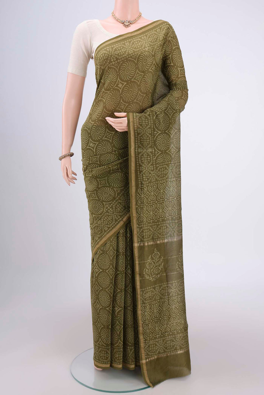 Olive Green Chanderi Silk Saree with Printed design on the body and Zari Border.  displayed on a mannequin