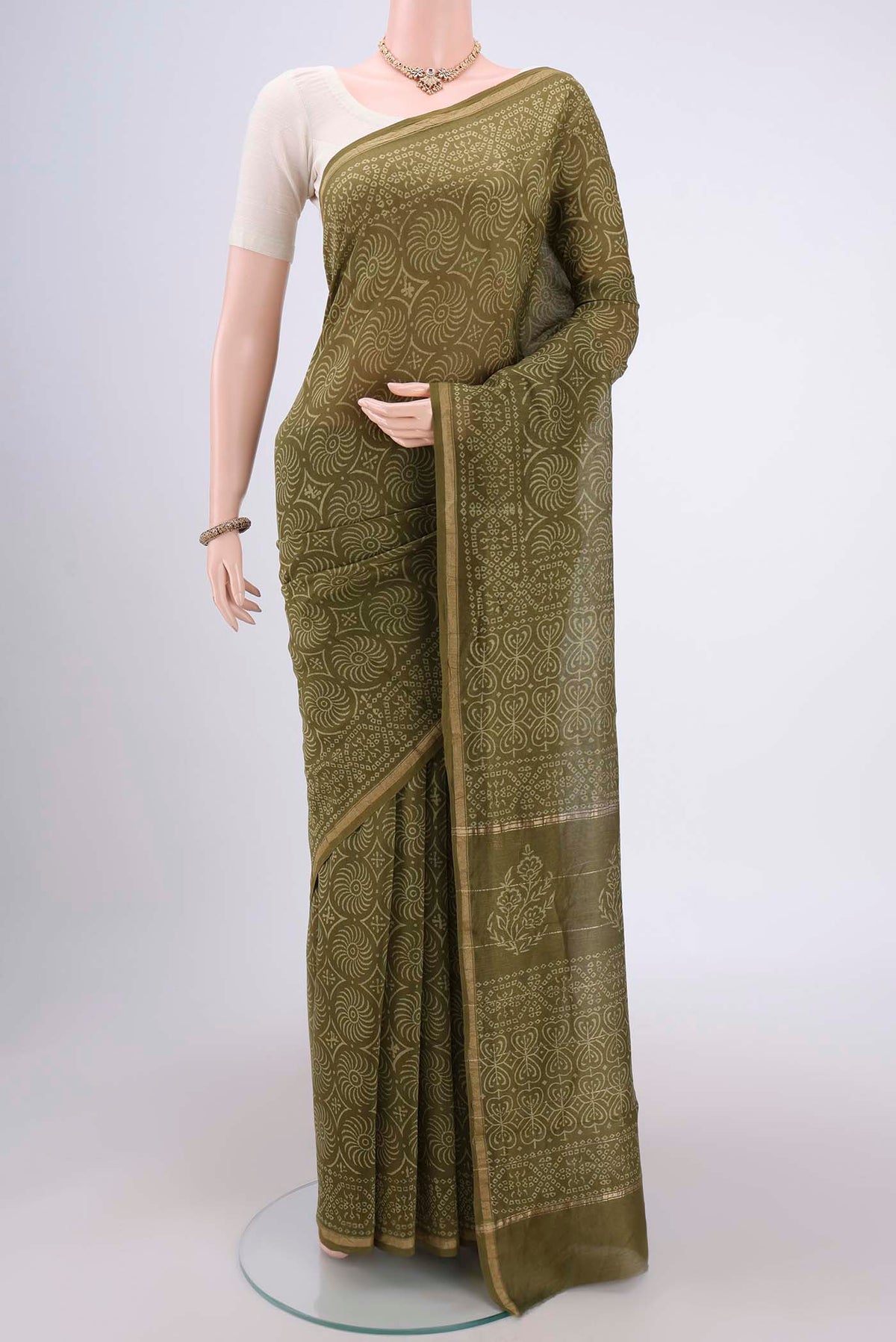 Olive Green Chanderi Silk Saree with Printed design on the body and Zari Border.  displayed on a mannequin
