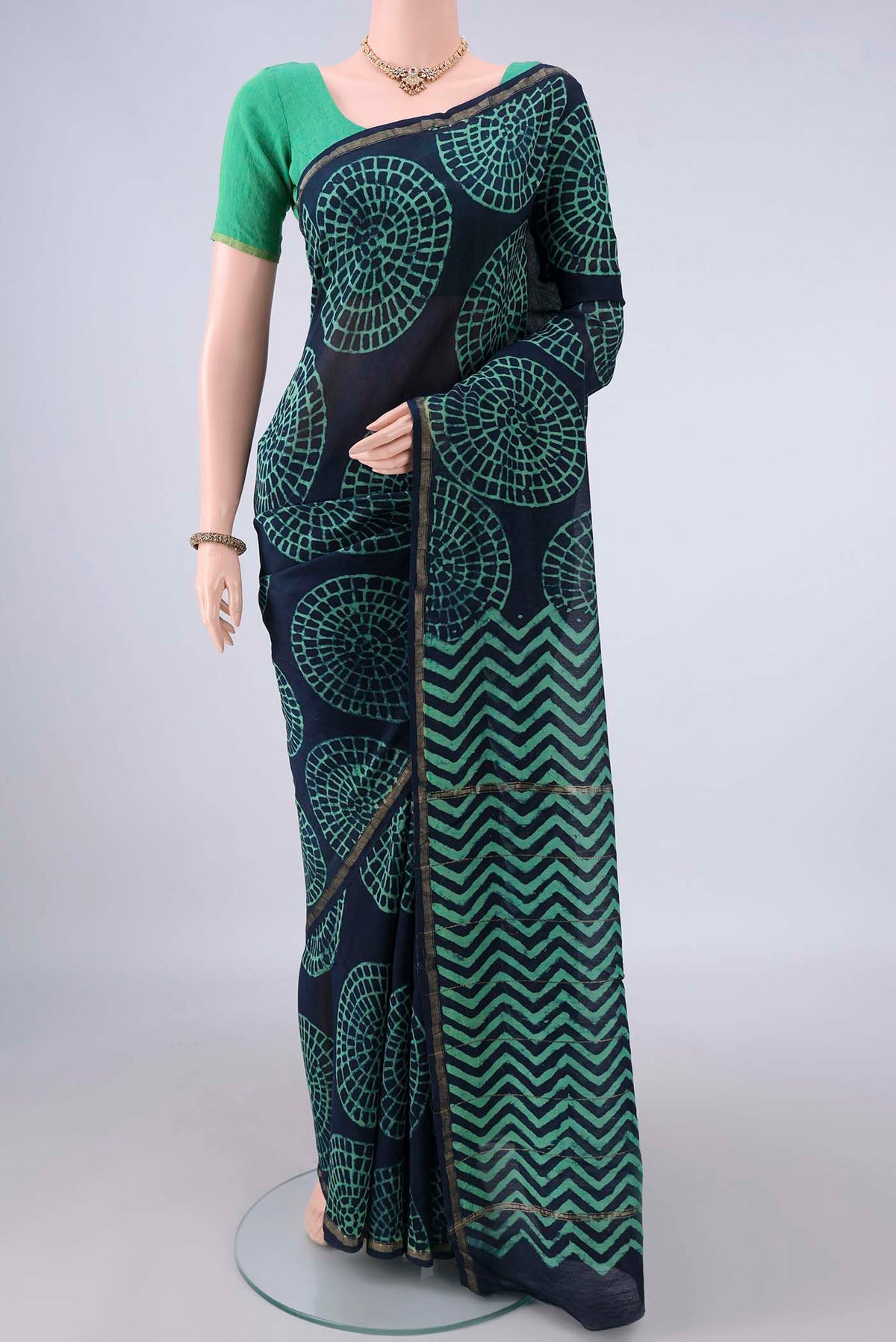 Indigo Chanderi Cotton Saree with Batik Print on the body and Thin Zari Line.  displayed on a mannequin
