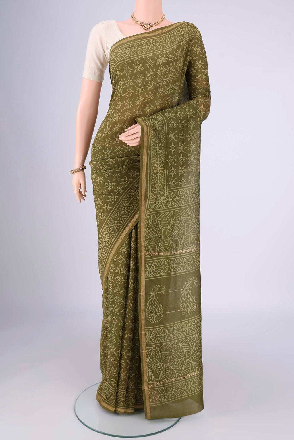 Mehandi Green Maheshwari Silk Cotton Saree with Batik Print on the body and Zari Border.  displayed on a mannequin
