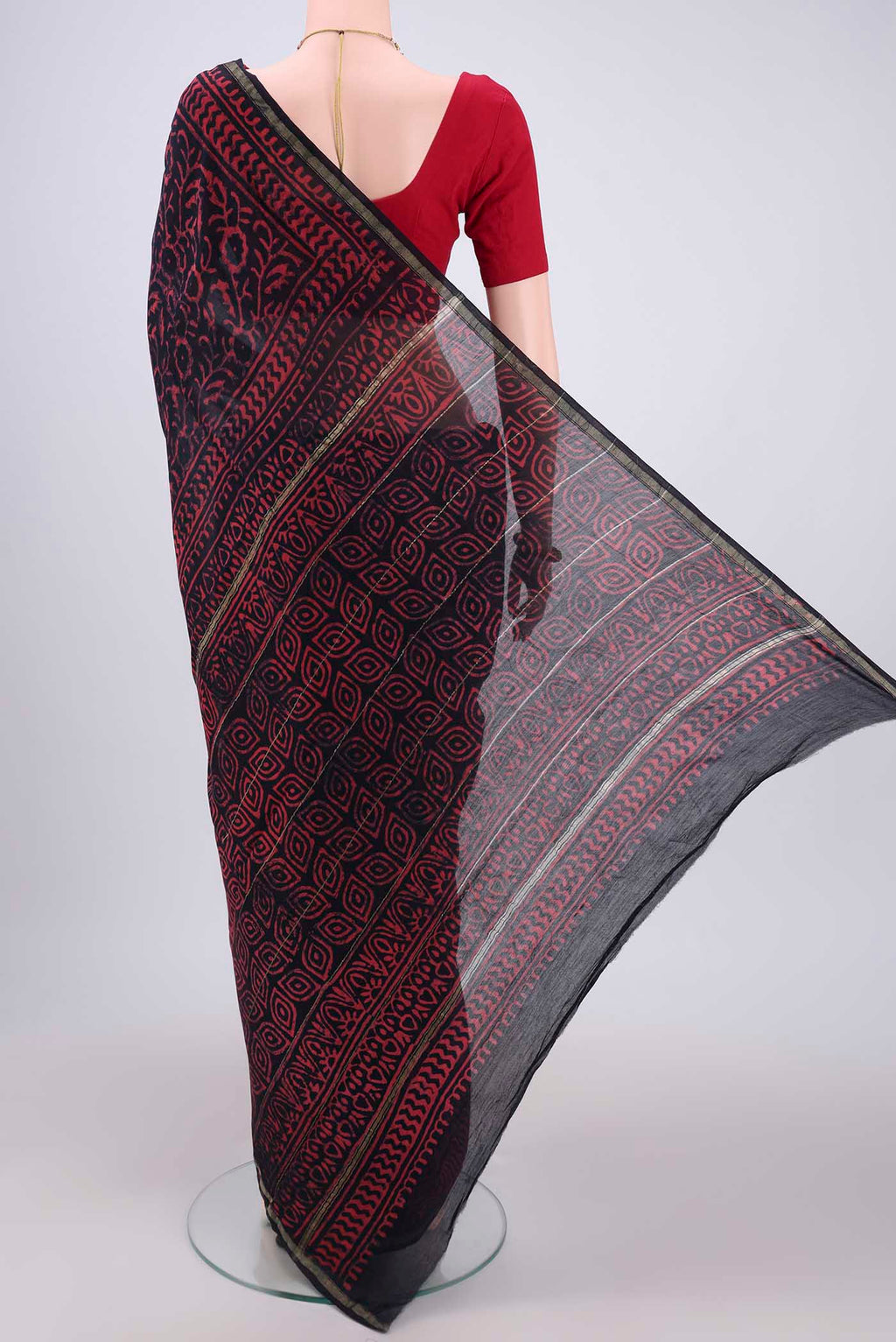 Flat view of Navy Blue Chanderi Silk Saree with Batik Print on the body and Zari Border. 