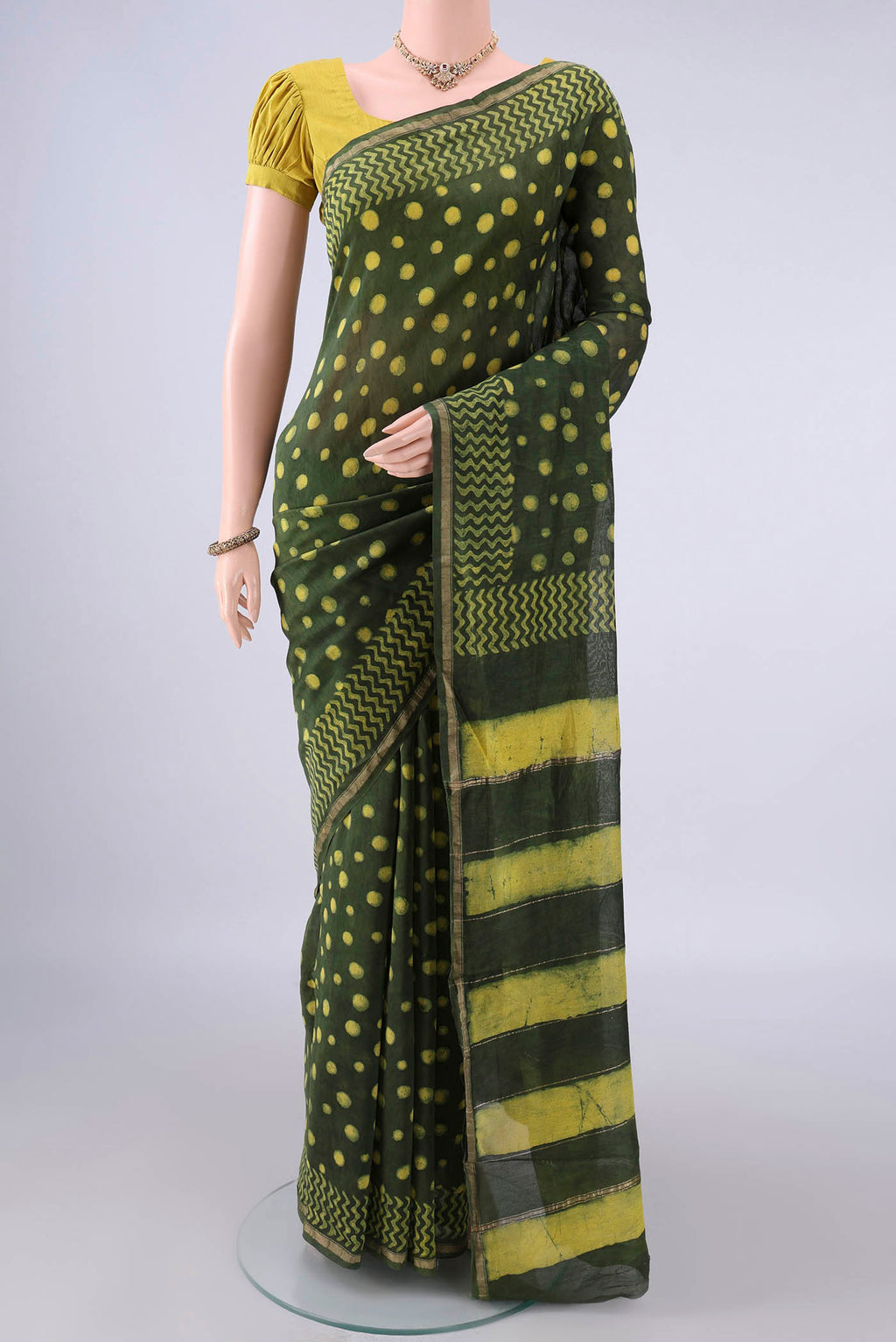 Mehandi Green Chanderi Cotton Saree with Batik Print on the body and Thin Zari Line.  displayed on a mannequin