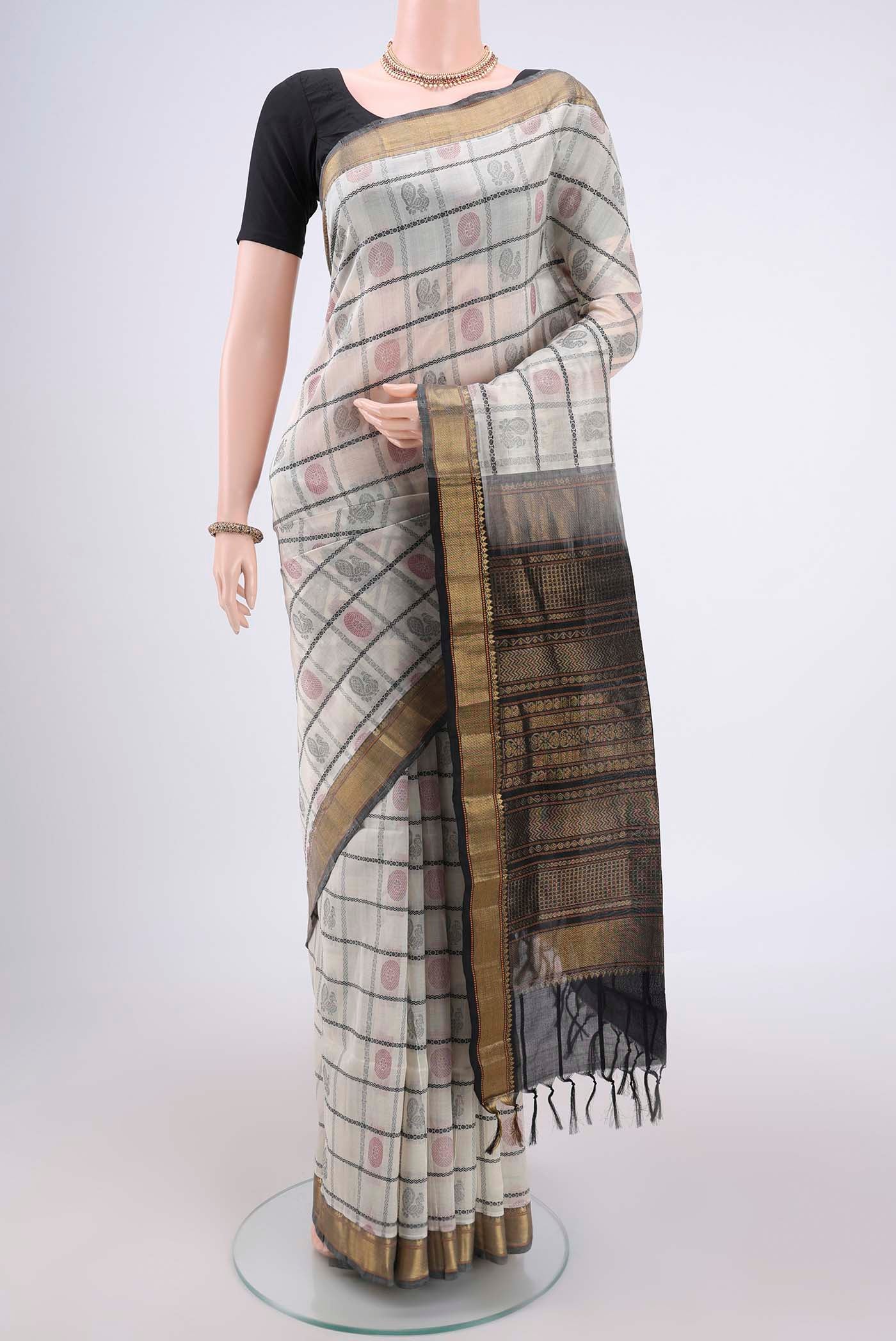 Off White Coimbatore Silk Cotton Saree with Checked design on the body and Zari Border.  displayed on a mannequin