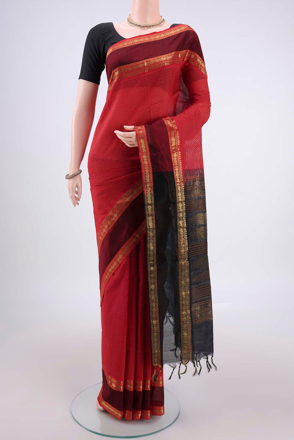 Red Coimbatore Silk Cotton Saree with Jacquard design on the body and Zari Border.  displayed on a mannequin