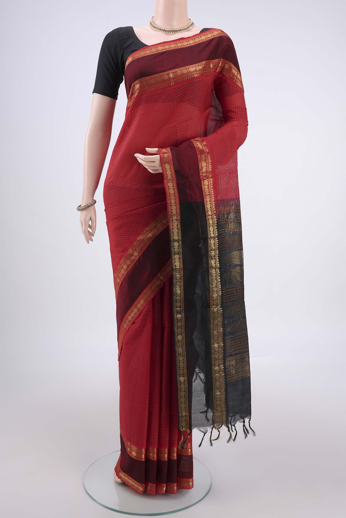 Red Coimbatore Silk Cotton Saree with Jacquard design on the body and Zari Border.  displayed on a mannequin