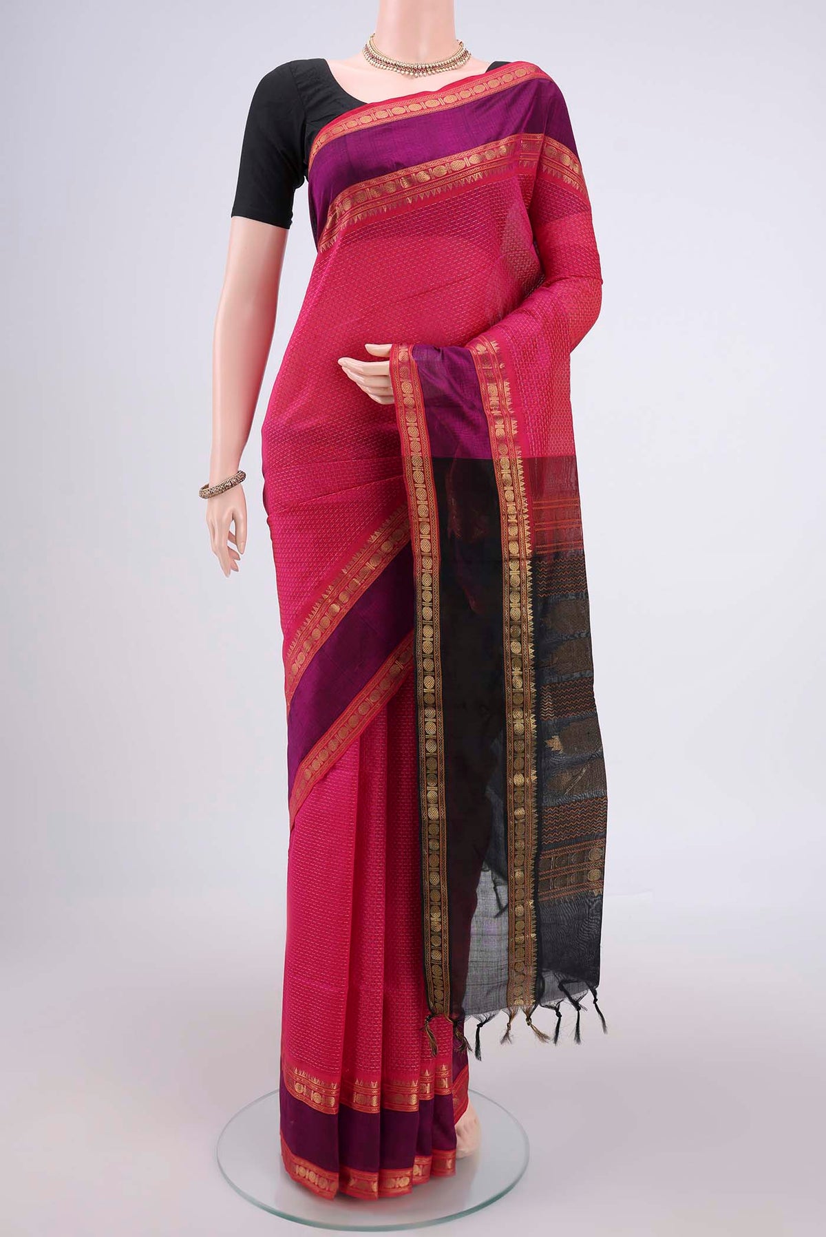 Rani Pink Coimbatore Silk Cotton Saree with Jacquard design on the body and Zari Border.  displayed on a mannequin