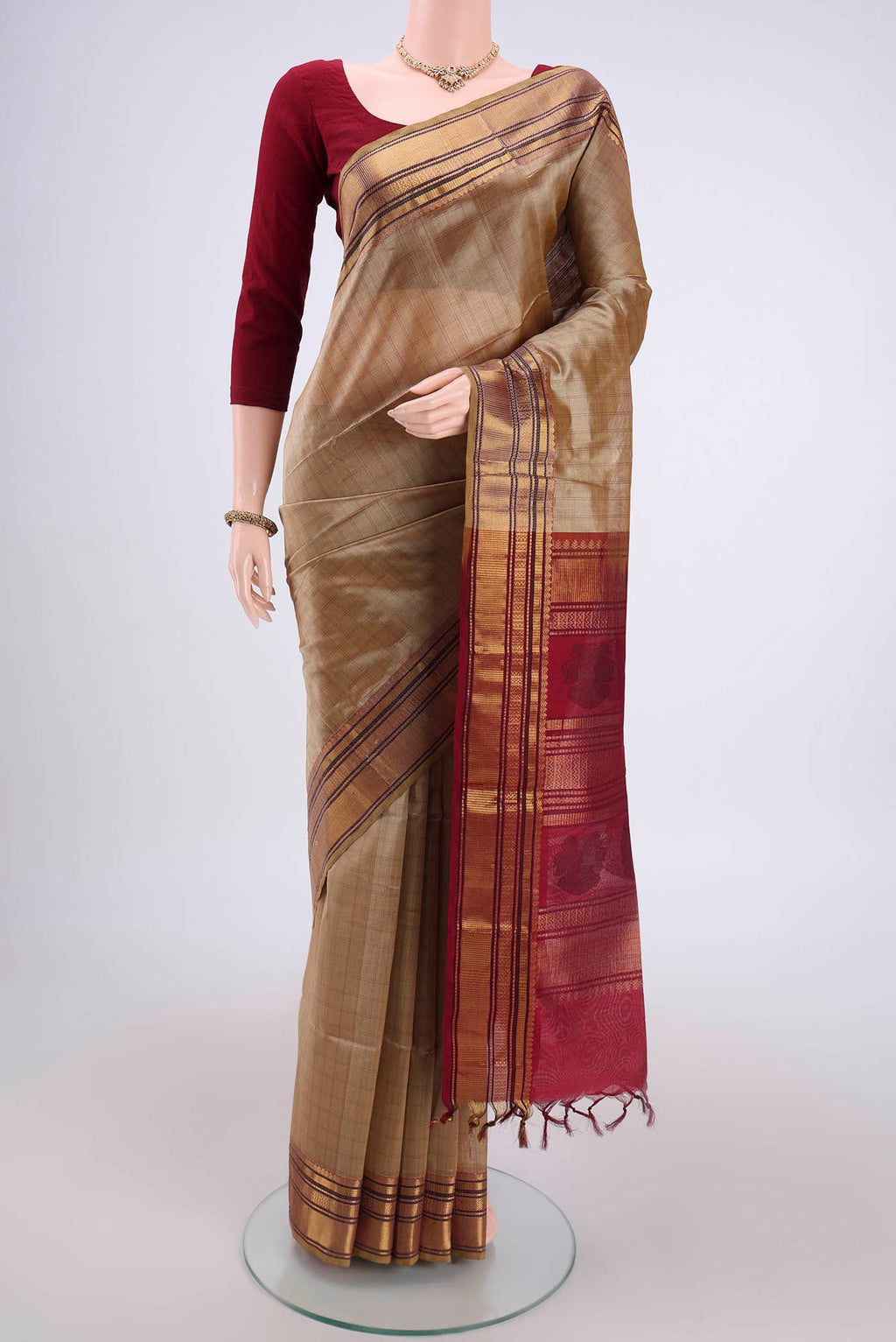 Dark Beige Coimbatore Silk Cotton Saree with Checked design on the body and Zari And Thread Border.  displayed on a mannequin