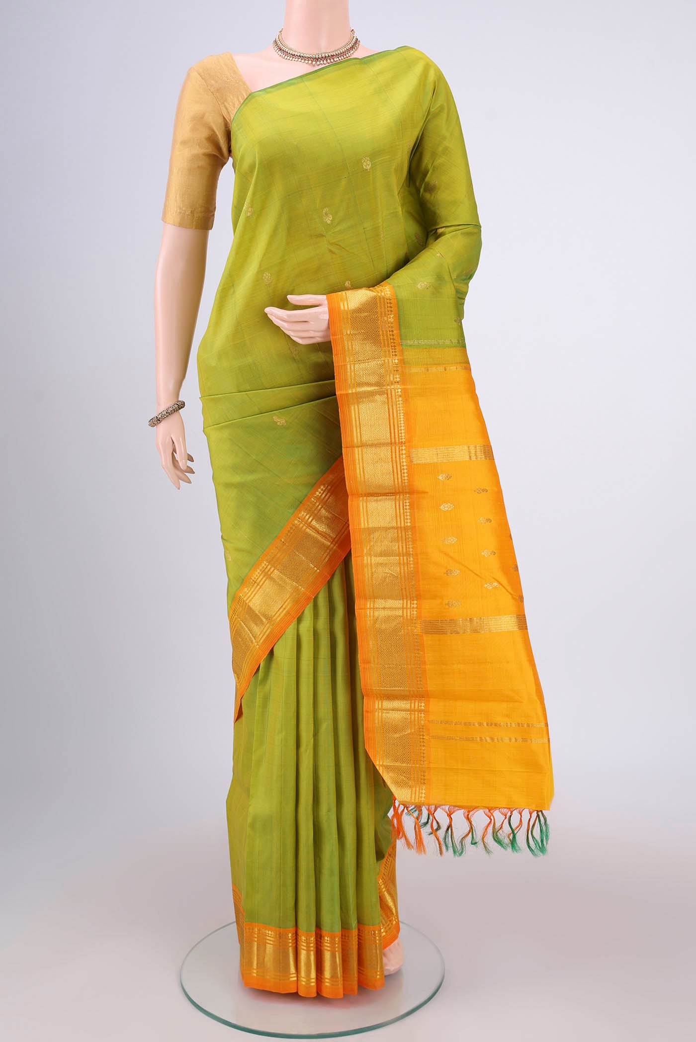 Light Green Kanjivaram Silk Saree with Plain Body and One Side Border.  displayed on a mannequin