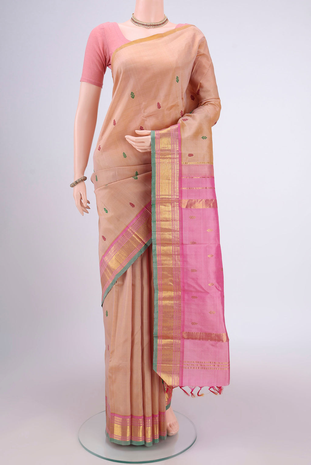Beige Kanjivaram Silk Saree with Thread Butta on the body and One Side Border.  displayed on a mannequin