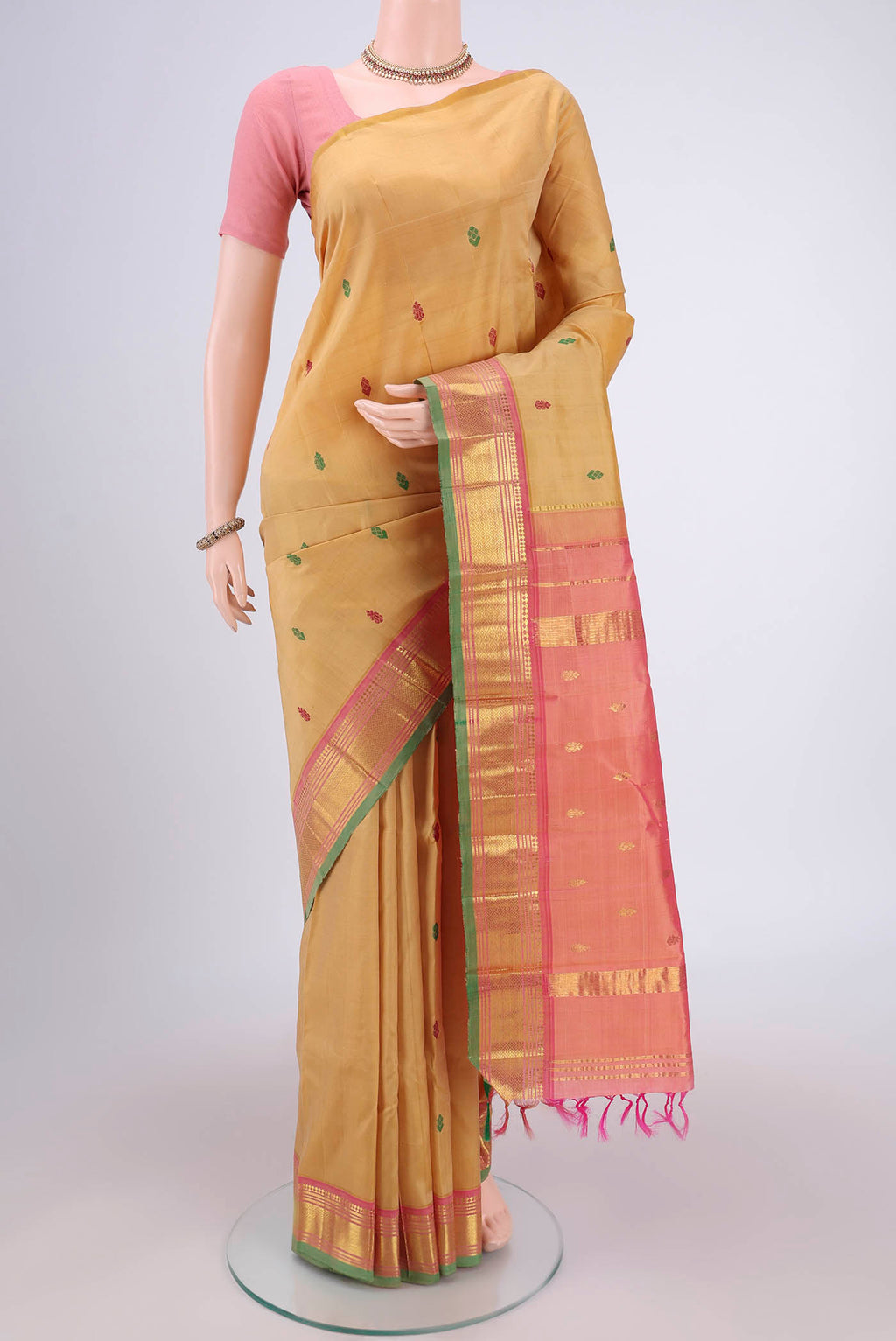 Beige Kanjivaram Silk Saree with Thread Butta on the body and One Side Border.  displayed on a mannequin