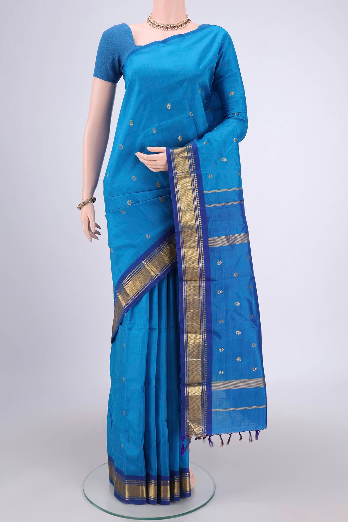 Blue Kanjivaram Silk Saree with Zari Butta on the body and One Side Border.  displayed on a mannequin