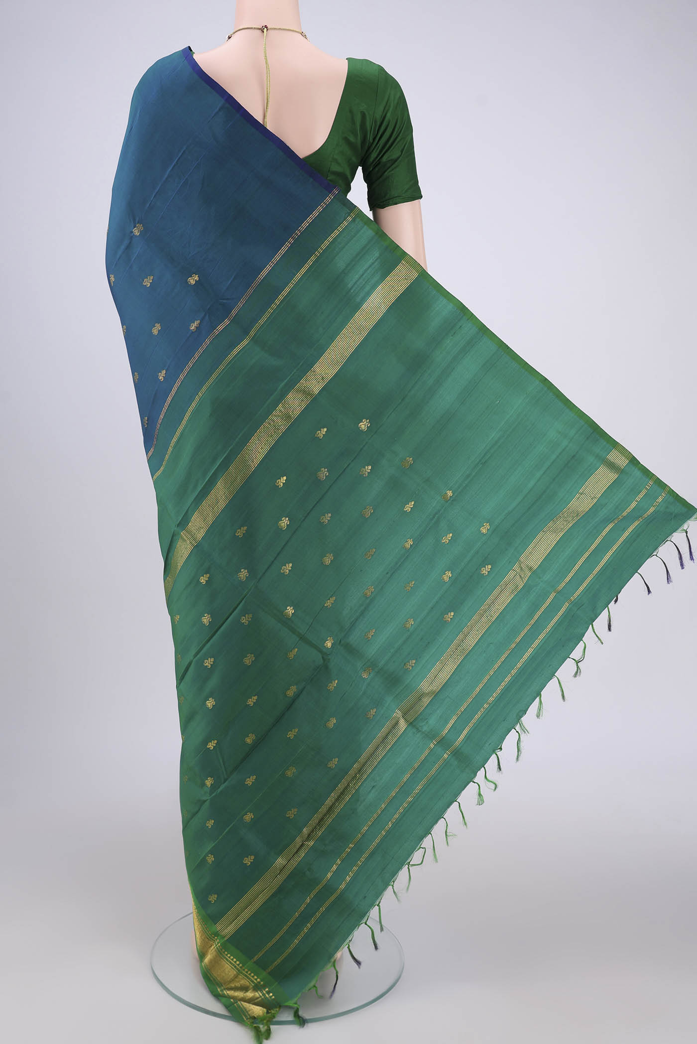 Flat view of Peacock Blue Kanjivaram Silk Saree with Zari Butta on the body and One Side Border. 