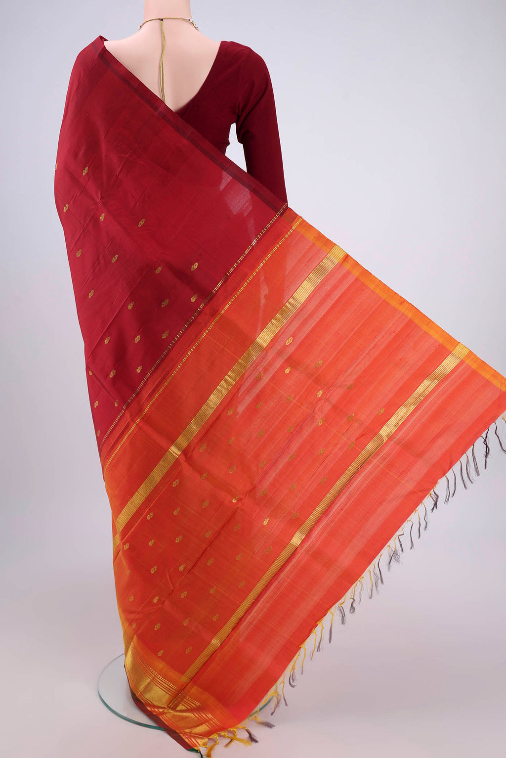 Flat view of Maroon Kanjivaram Silk Saree with Zari Butta on the body and One Side Border. 