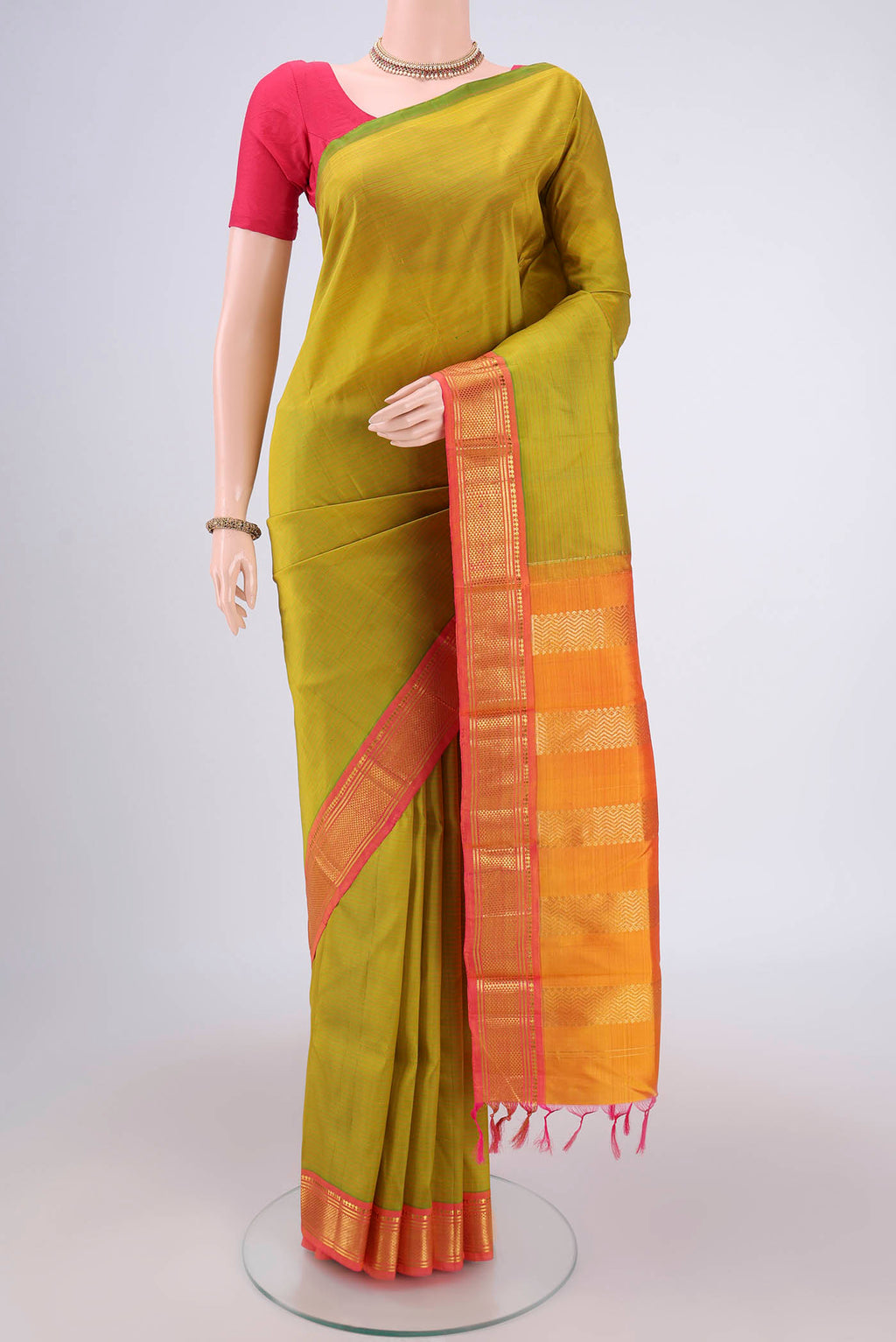 Light Green Kanjivaram Silk Saree with Stripes on the body and One Side Border.  displayed on a mannequin