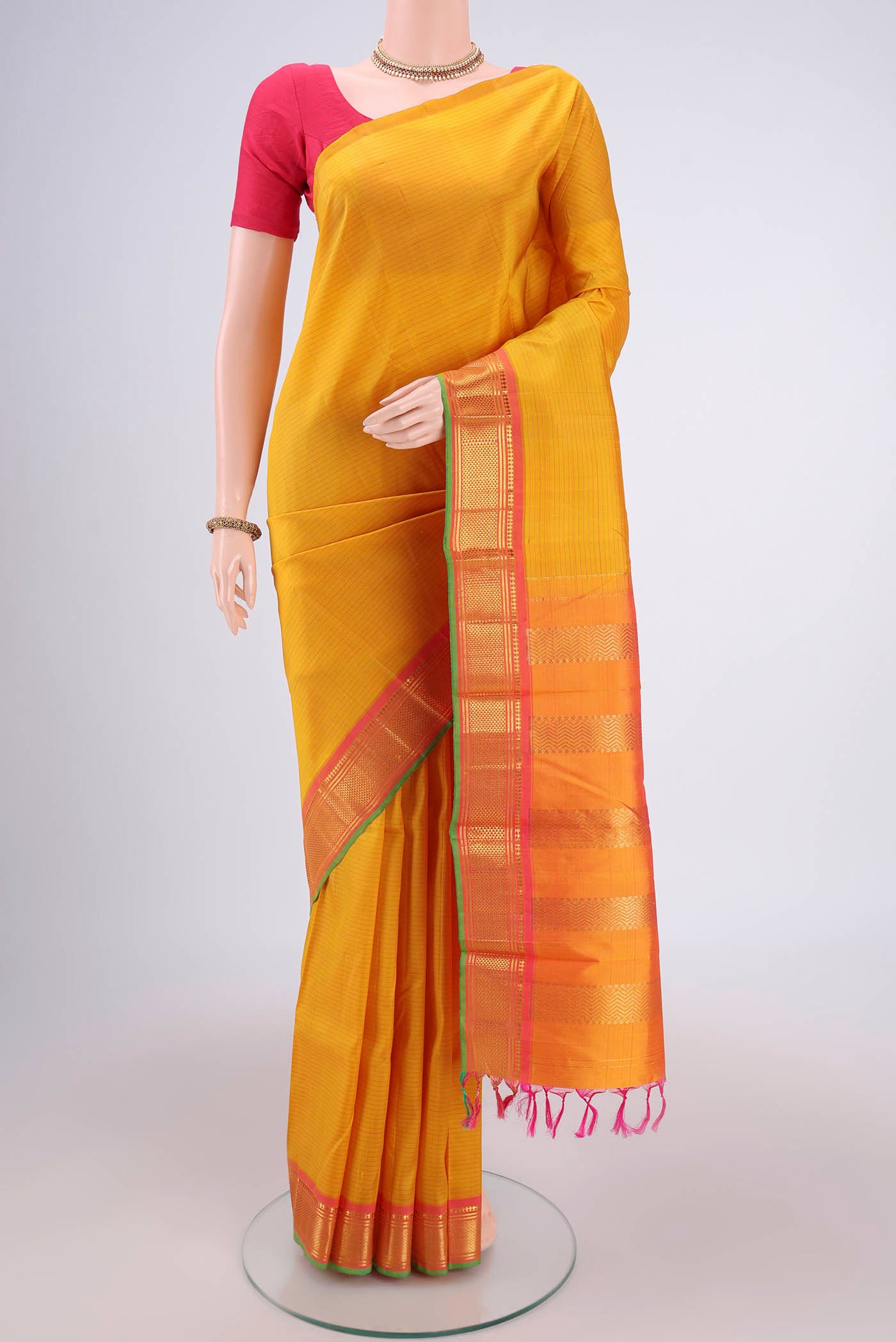 Mustard Kanjivaram Silk Saree with Stripes on the body and One Side Border.  displayed on a mannequin