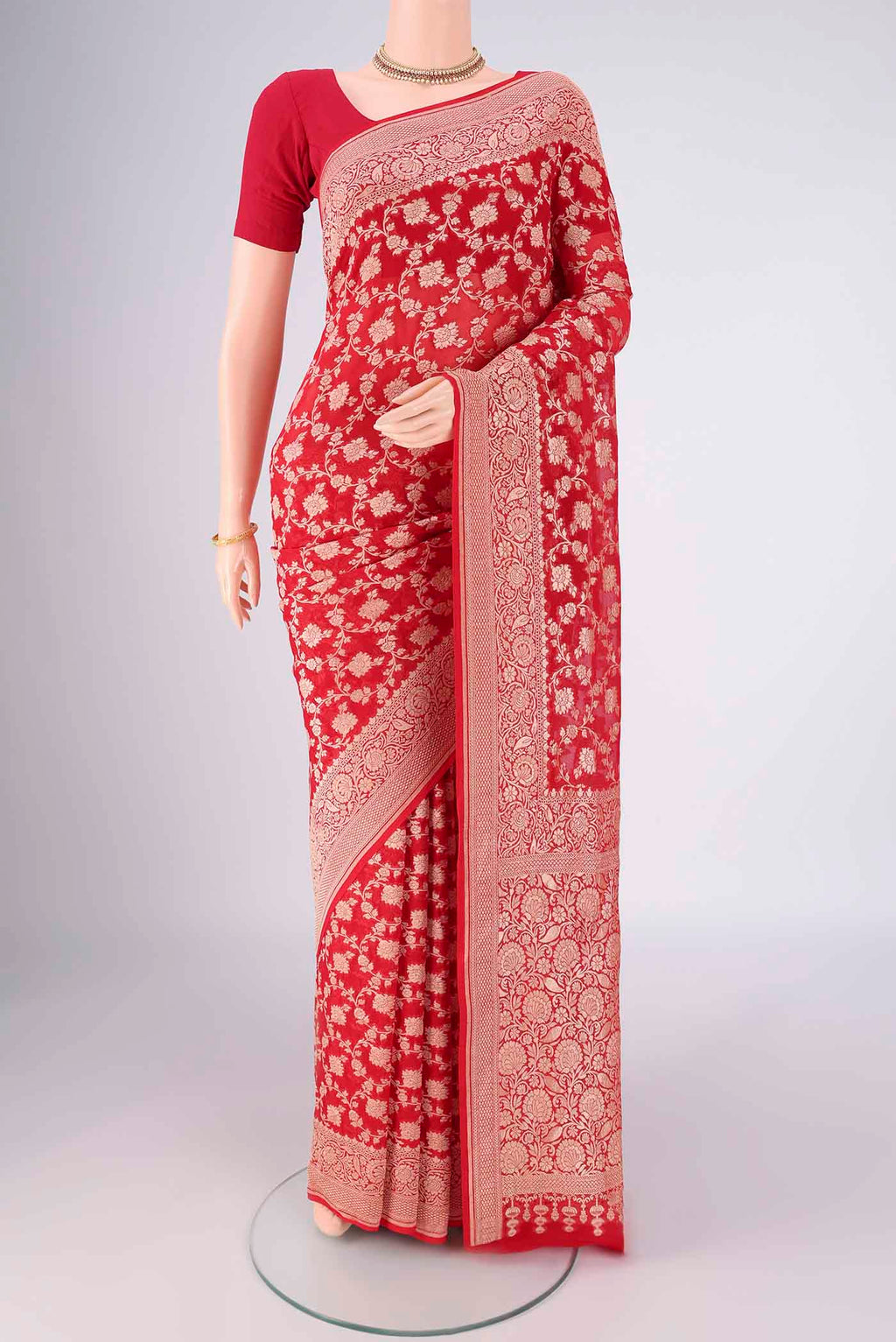 Red Banarasi Georgette Saree with Zari Brocade on the body and Zari Border.  displayed on a mannequin