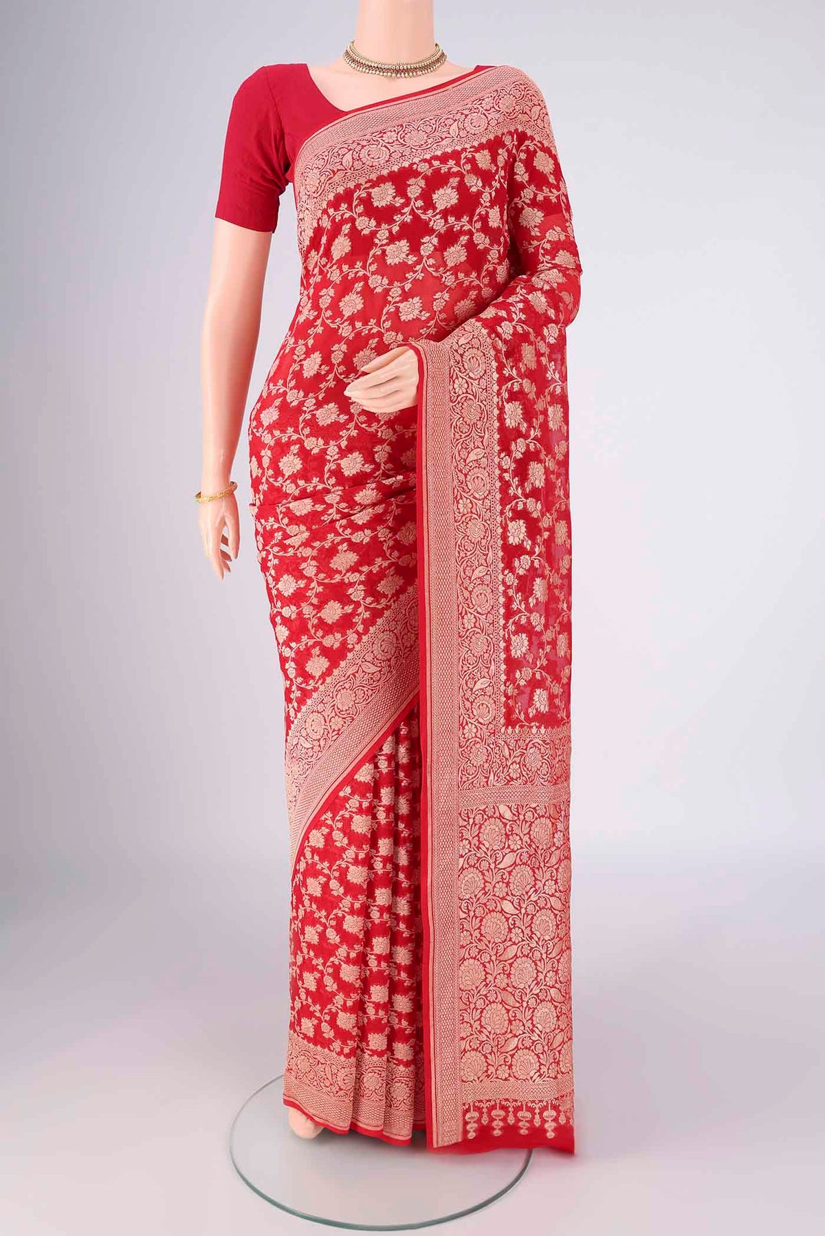 Red Banarasi Georgette Saree with Zari Brocade on the body and Zari Border.  displayed on a mannequin