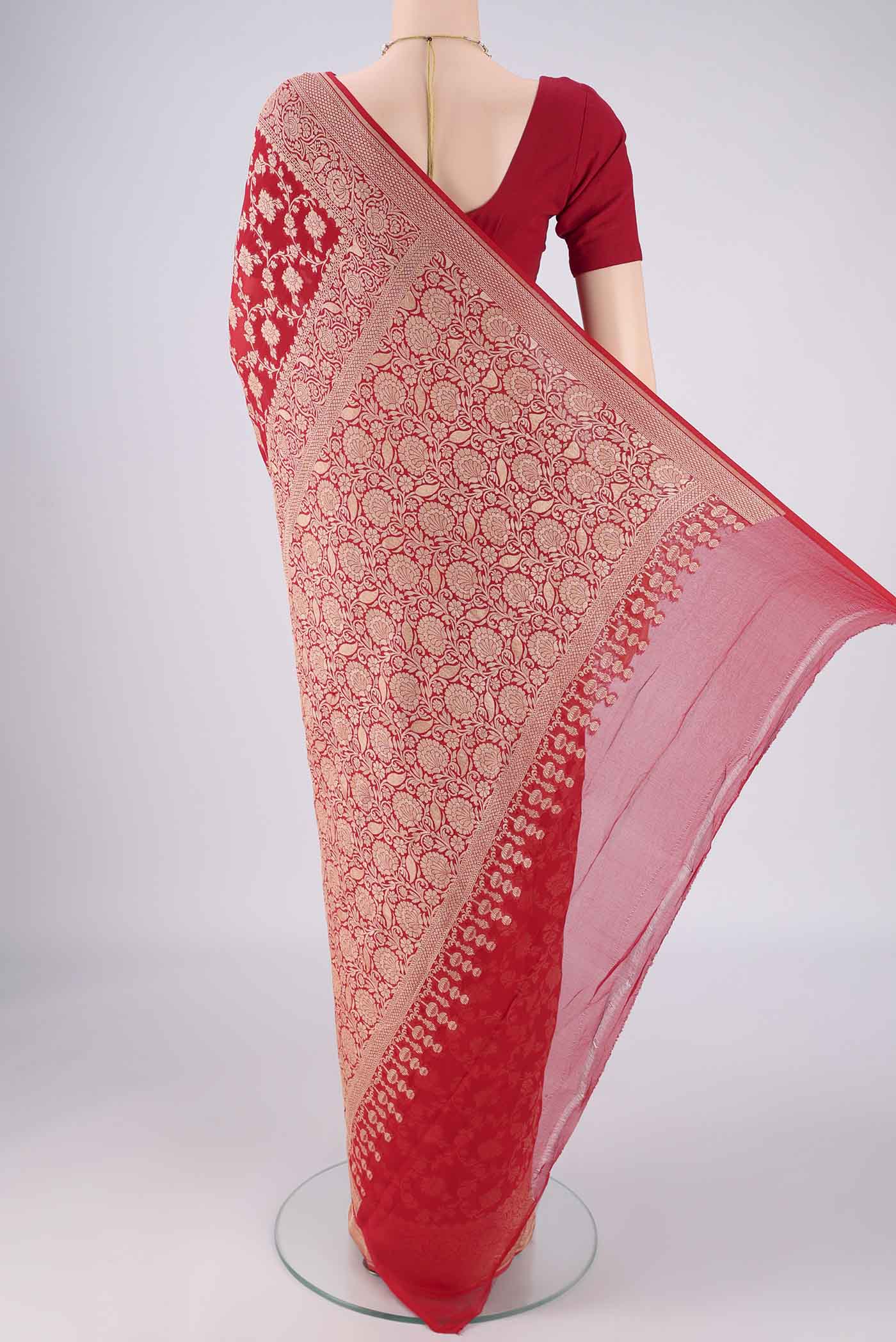 Flat view of Red Banarasi Georgette Saree with Zari Brocade on the body and Zari Border. 