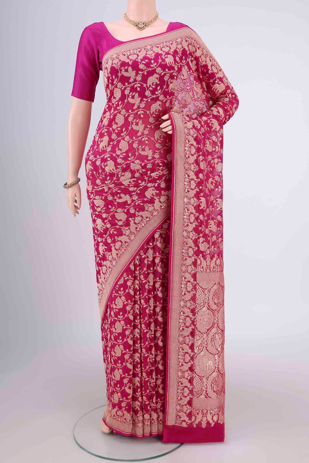 Rani Pink Banarasi Georgette Saree with Zari Brocade on the body and Zari Border.  displayed on a mannequin