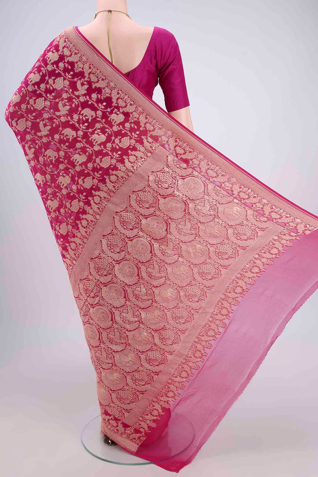 Flat view of Rani Pink Banarasi Georgette Saree with Zari Brocade on the body and Zari Border. 