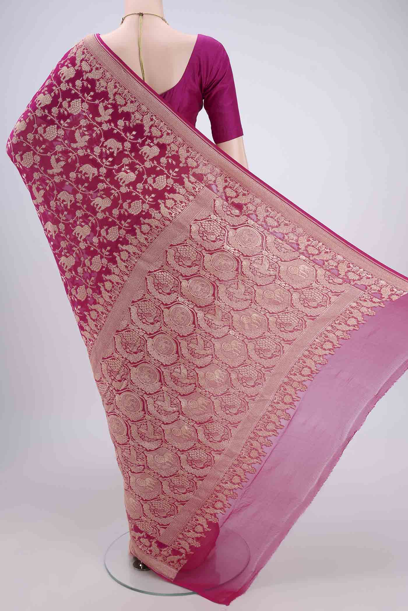 Flat view of Rani Pink Banarasi Georgette Saree with Zari Brocade on the body and Zari Border. 