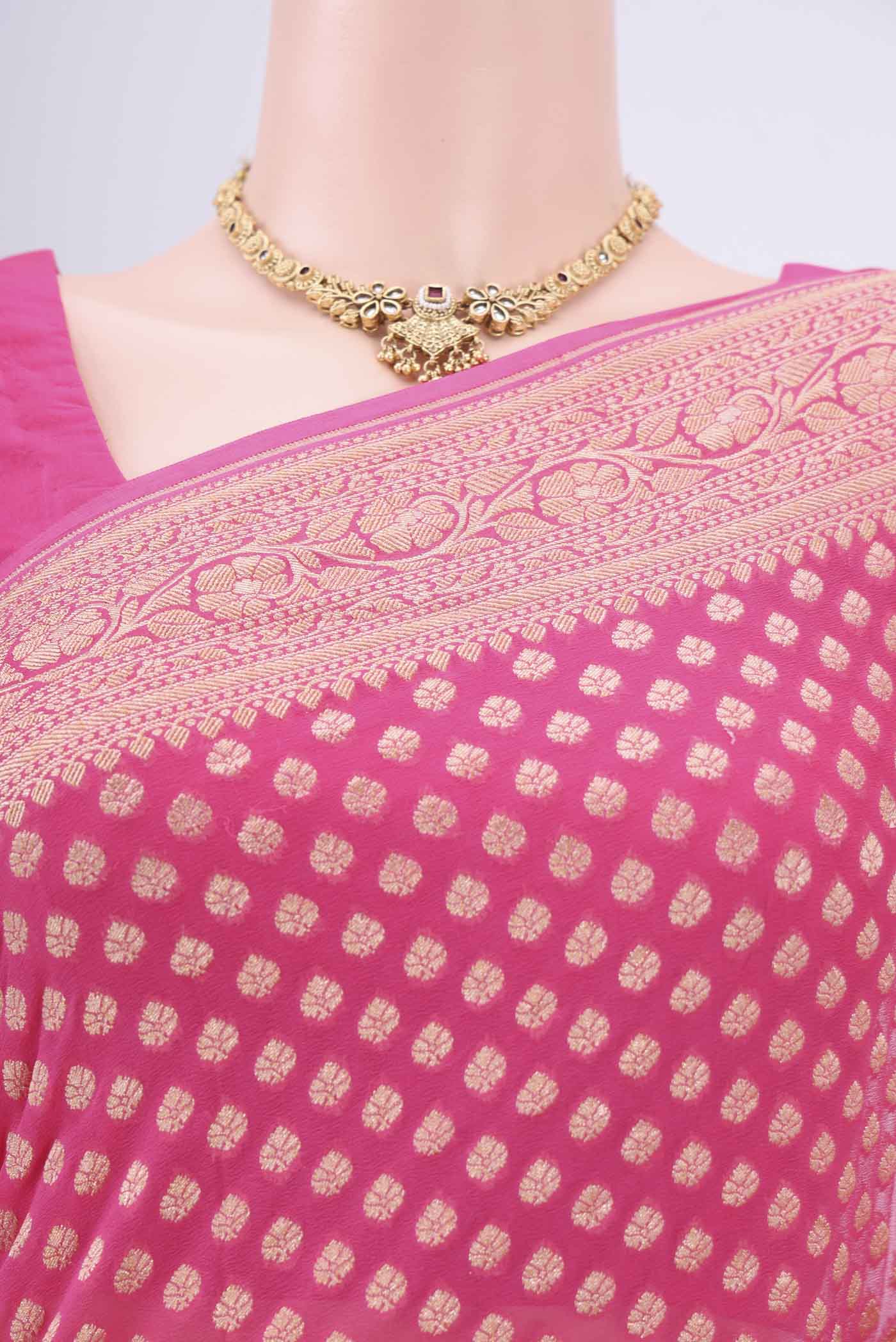 Border image of Rani Pink Banarasi Georgette Saree with Zari Butta on the body and Zari Border. 