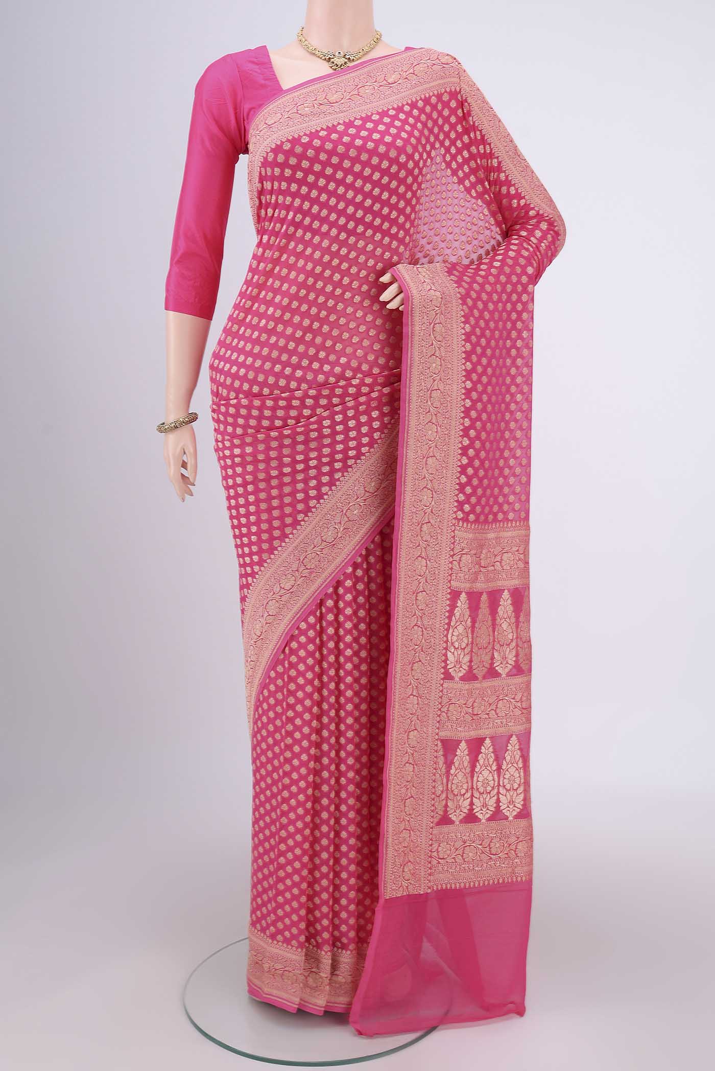 Rani Pink Banarasi Georgette Saree with Zari Butta on the body and Zari Border.  displayed on a mannequin